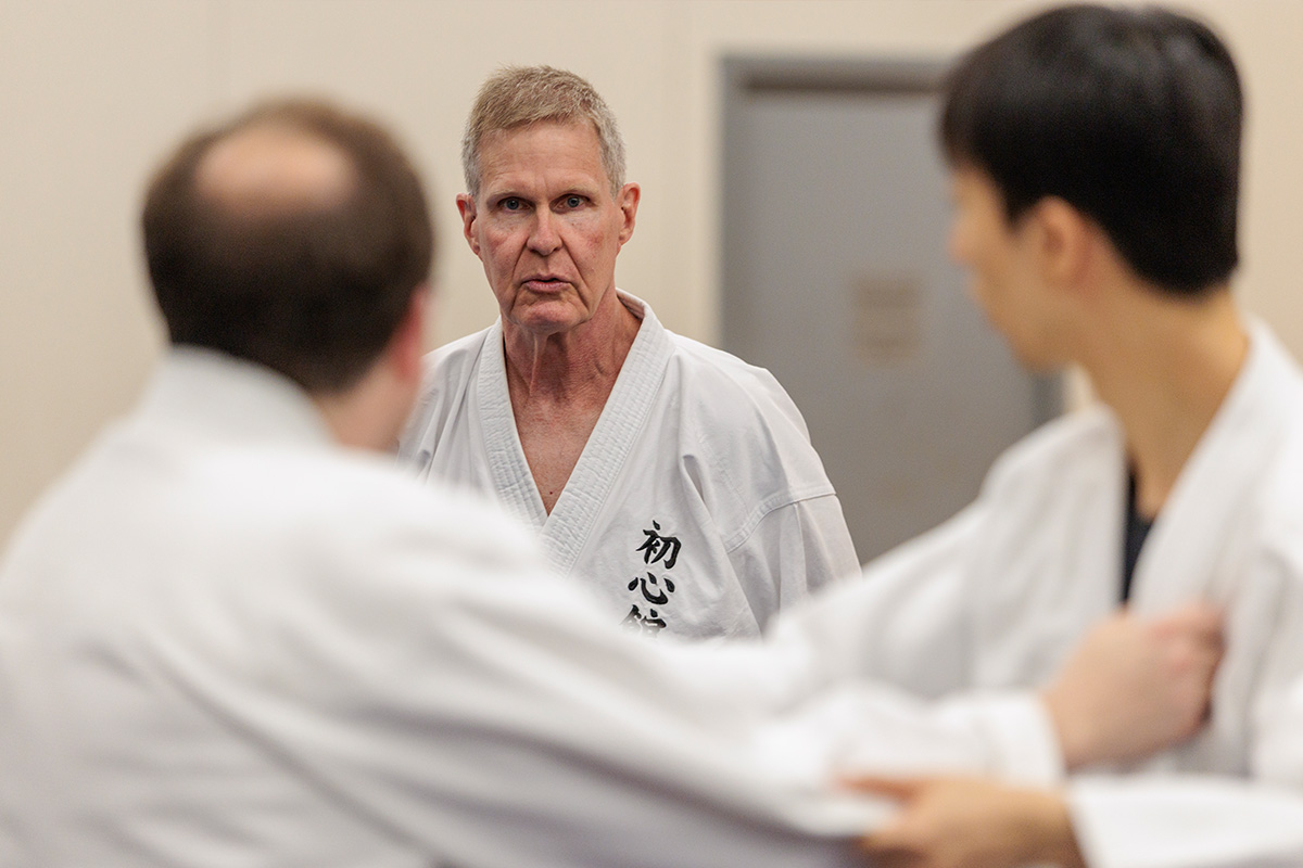 Jon Tupitza watching two students practicing Judo