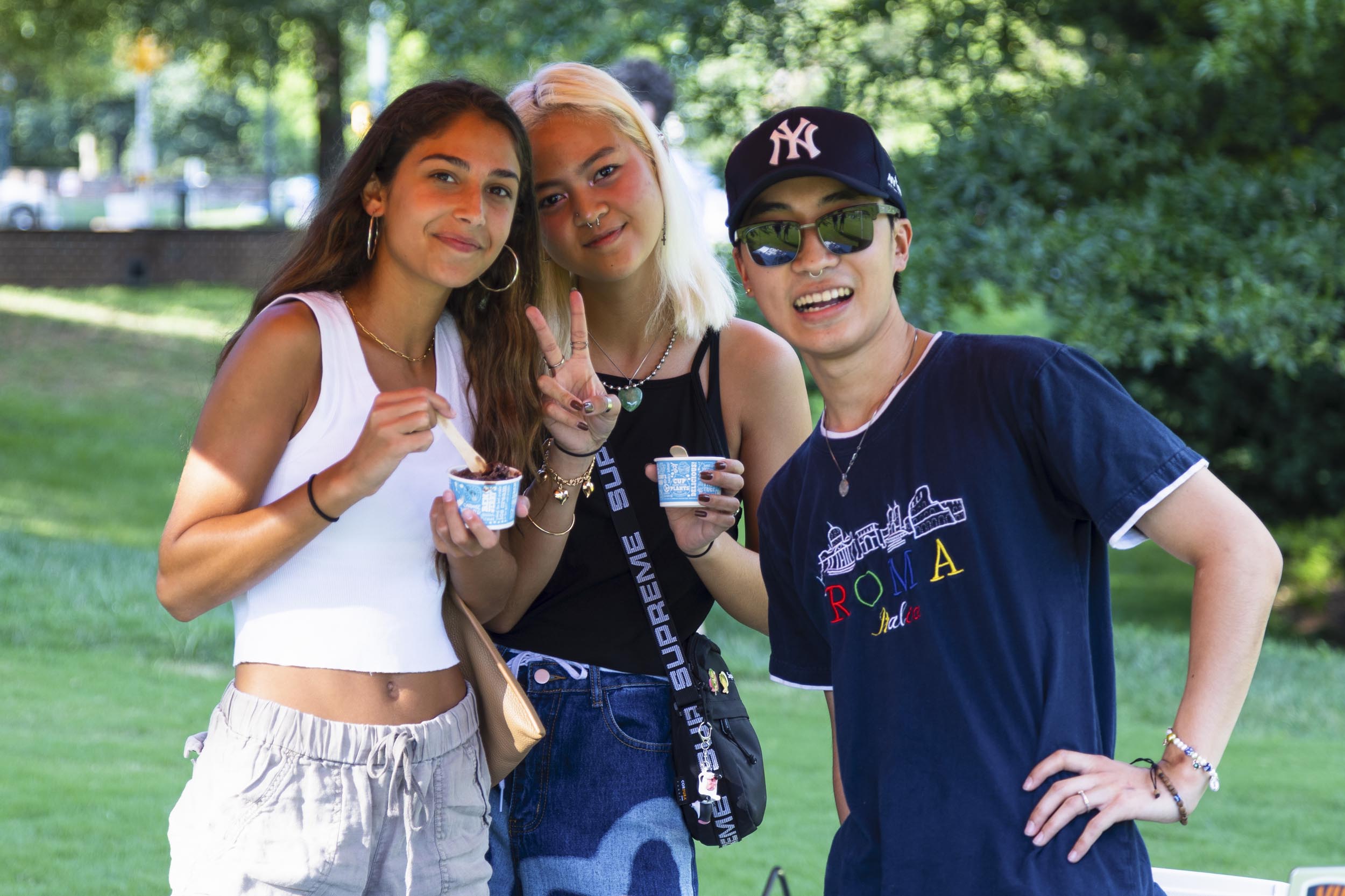 3 students pose together while they hold their icecream
