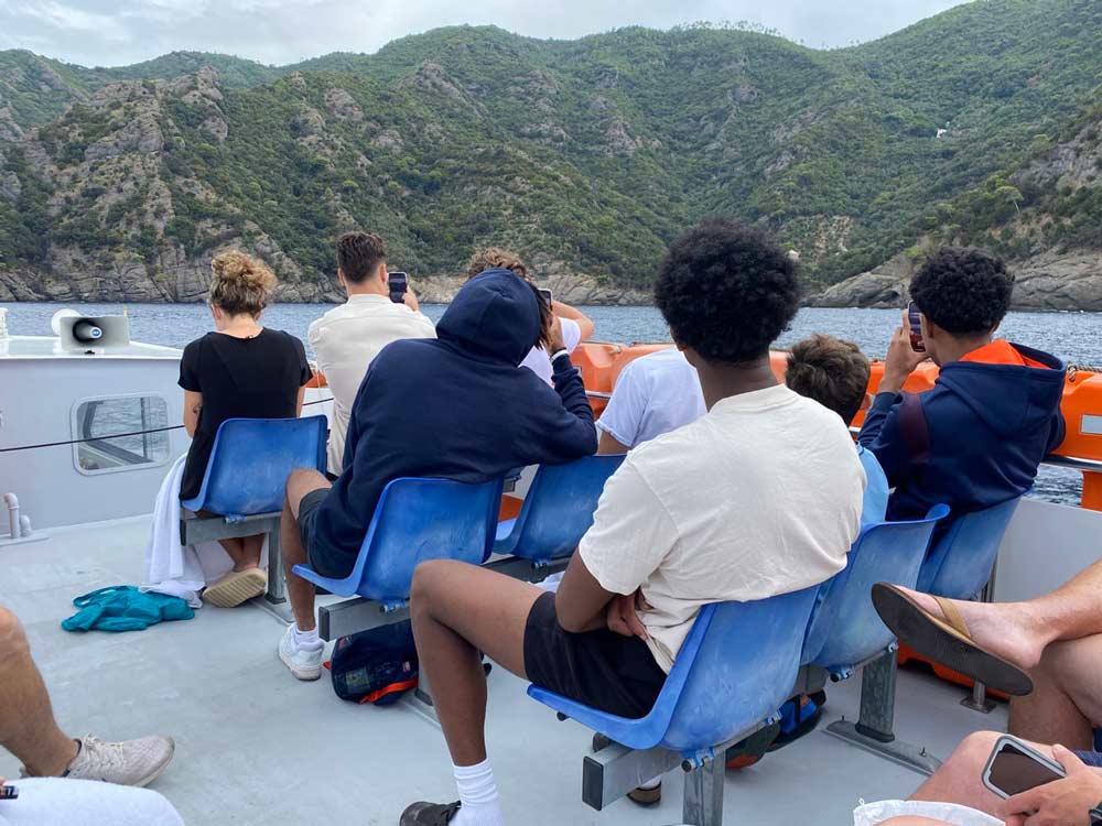 The basketball team takes in the italian scenery on a boat tour.