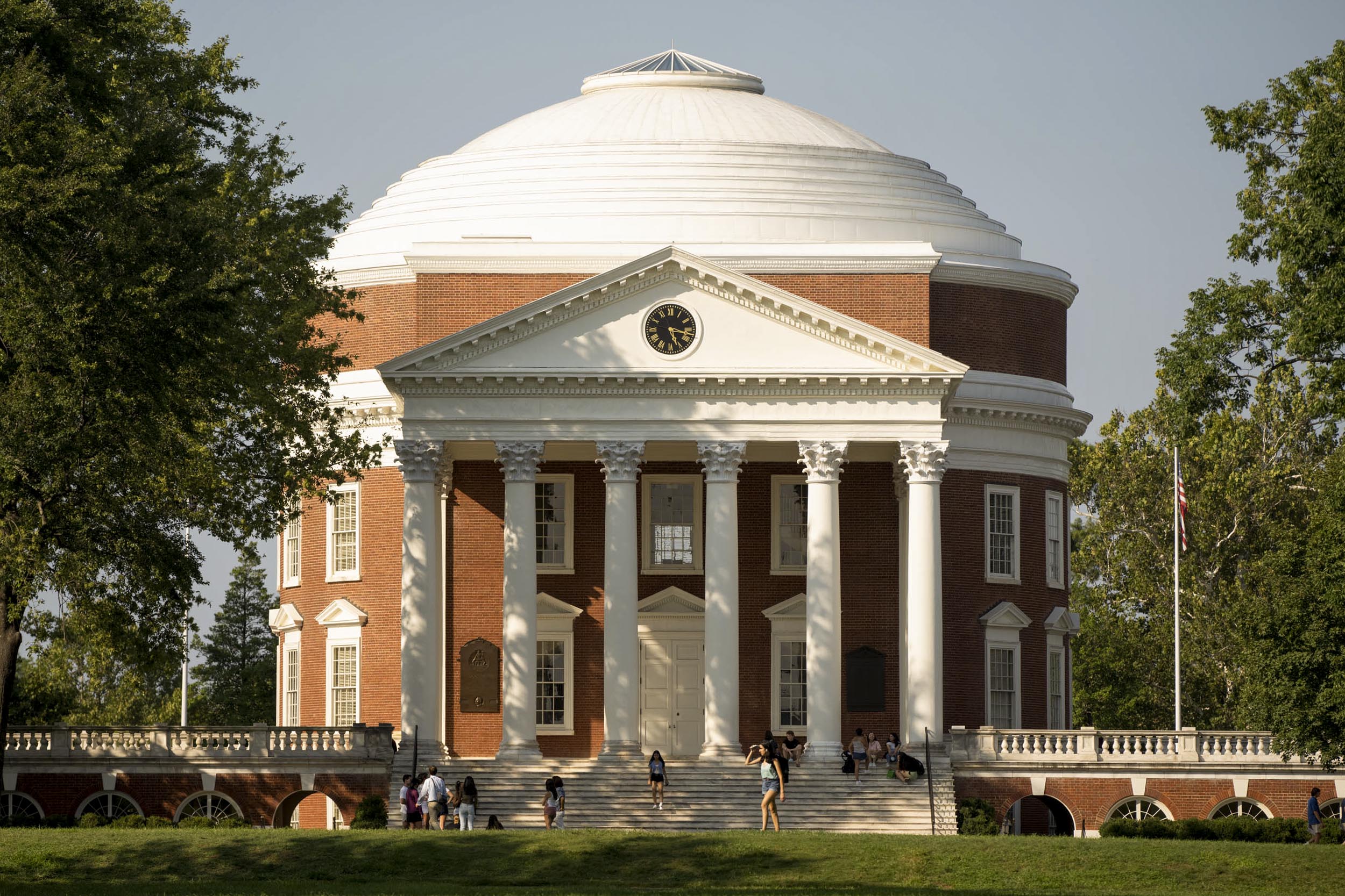 Rotunda with students walking and sitting on the steps