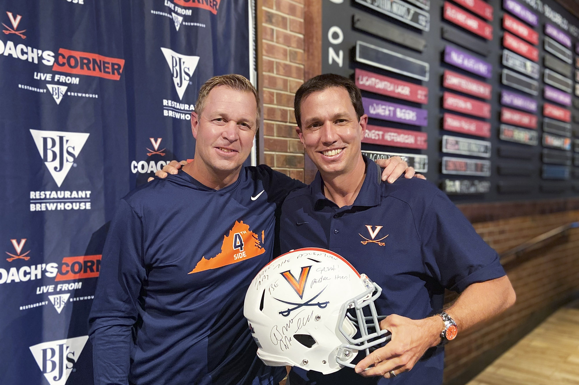 Bronco Mendenhall presents Dave Koehn a signed football helmet