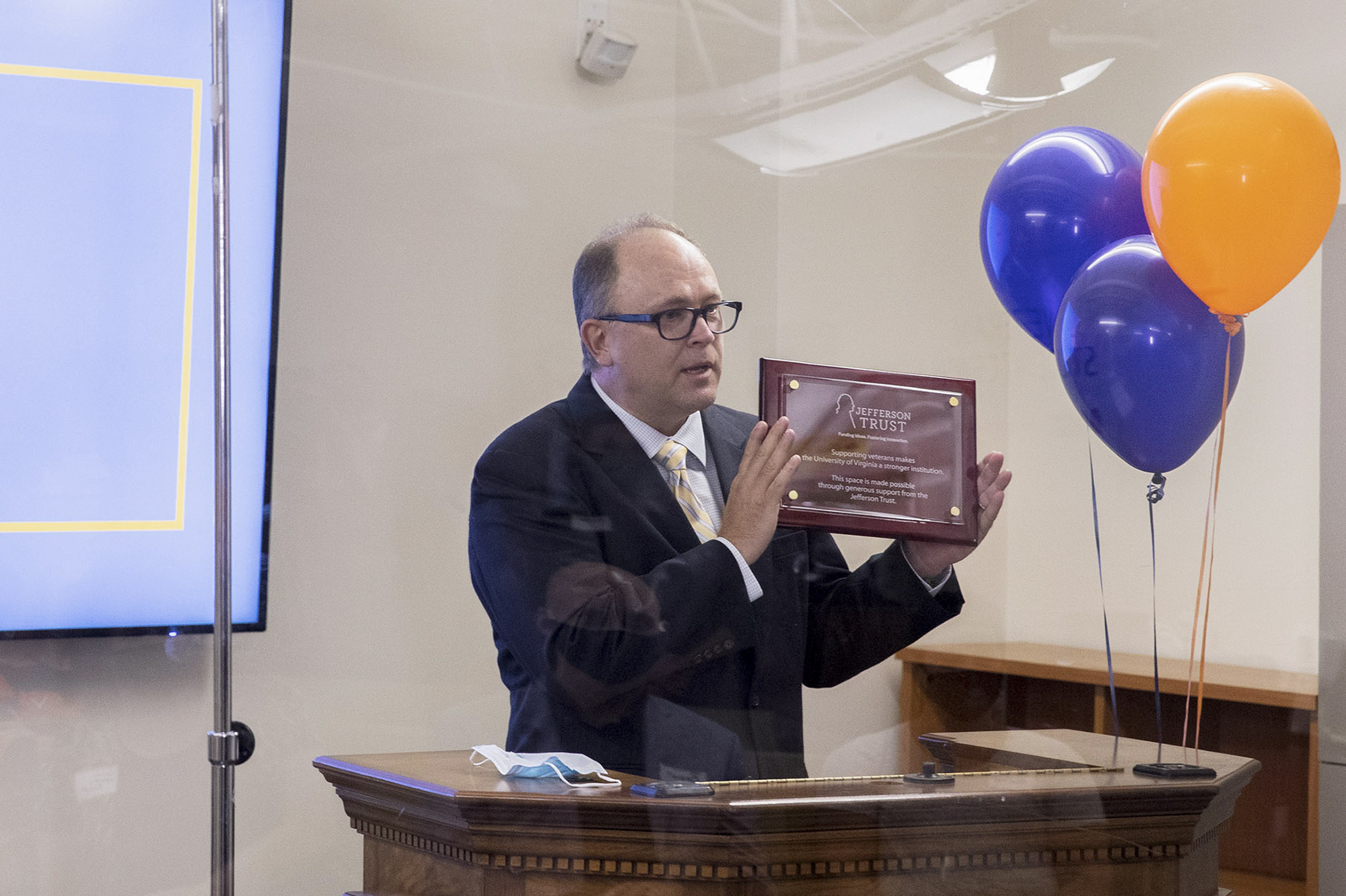 David Sauerwein holding a plaque at a podium