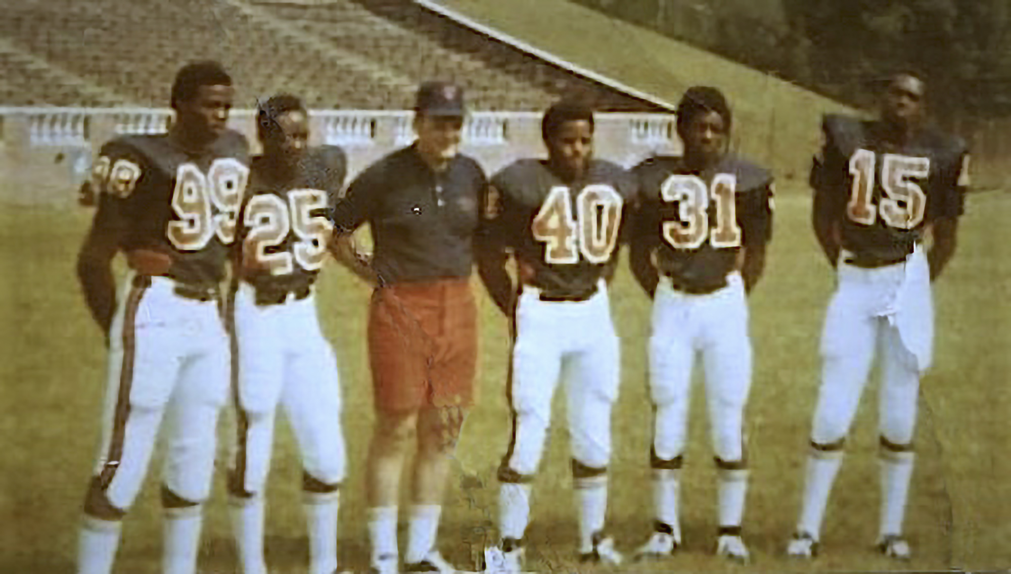 Gary Ham (31) with teammates Stanley Land (99), Kent Merritt (25), John Rainey (40), Harrison Davis (15) and head coach Don Lawrence (third from the left).