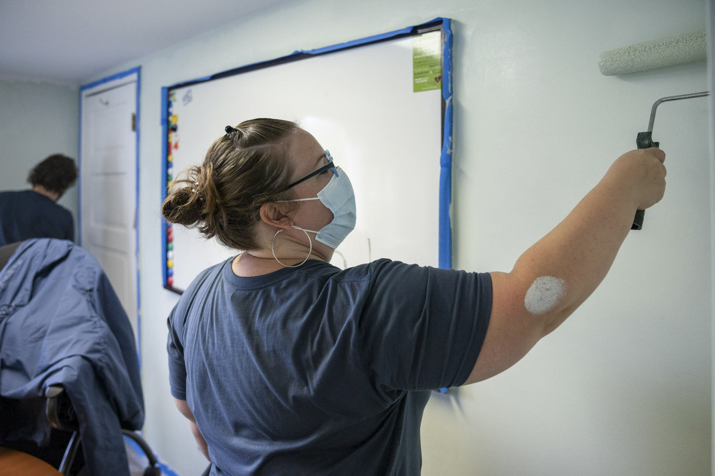 UVA staff member painting a wall