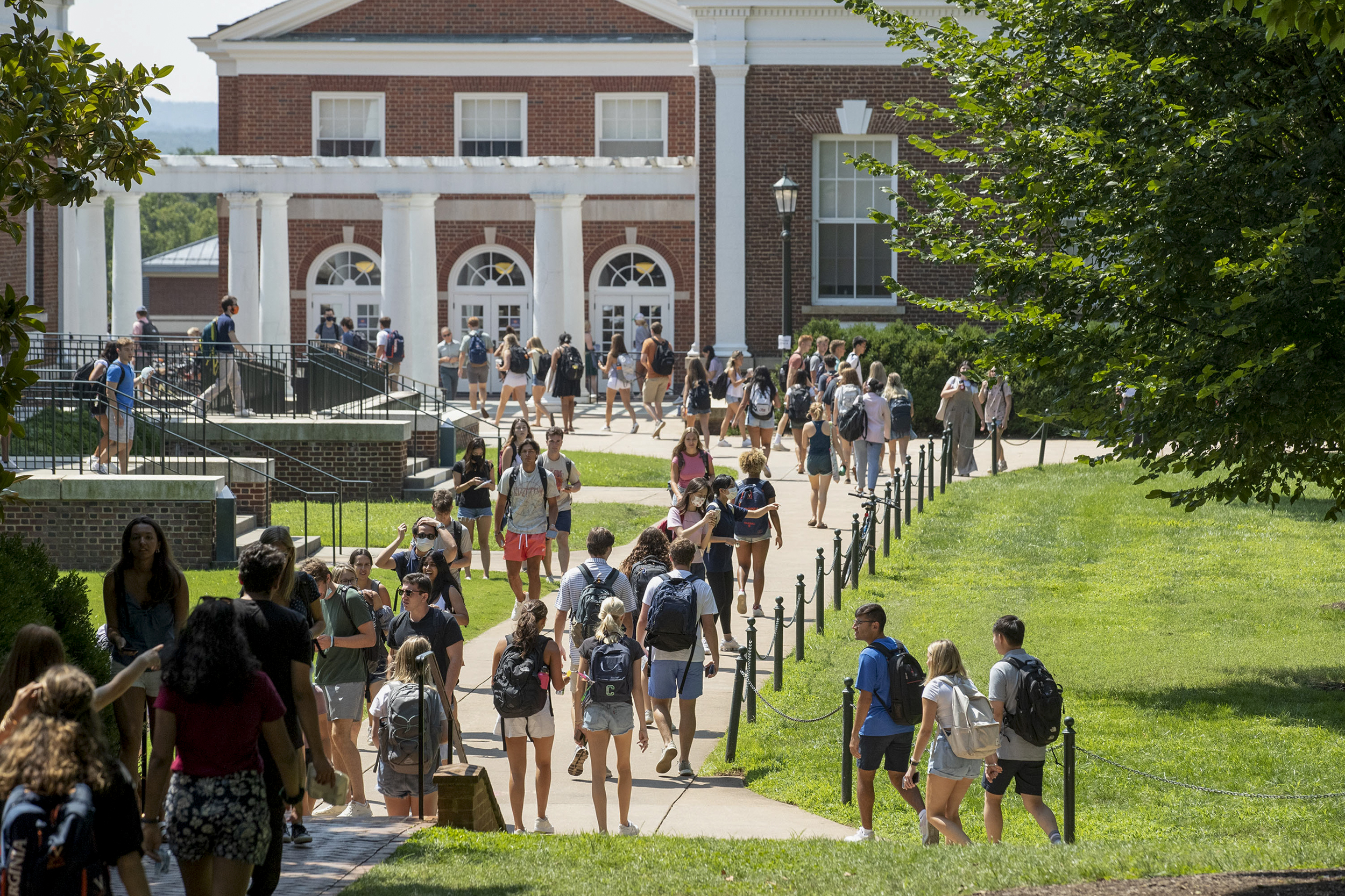 Students walking on a sidewalk to and from classes
