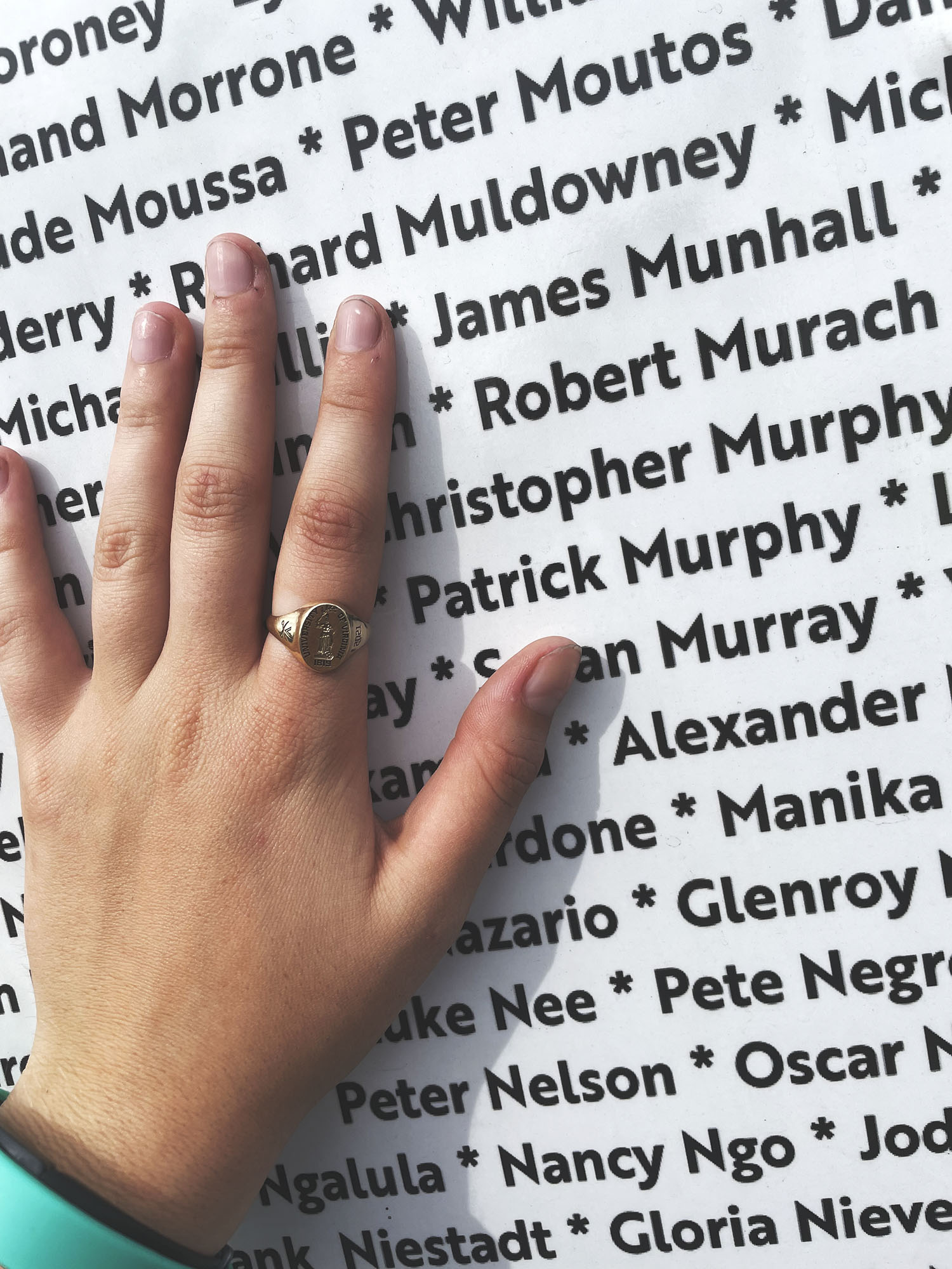 Hand over top of names of individuals who lost their lives during the September 11th terrorist attacks