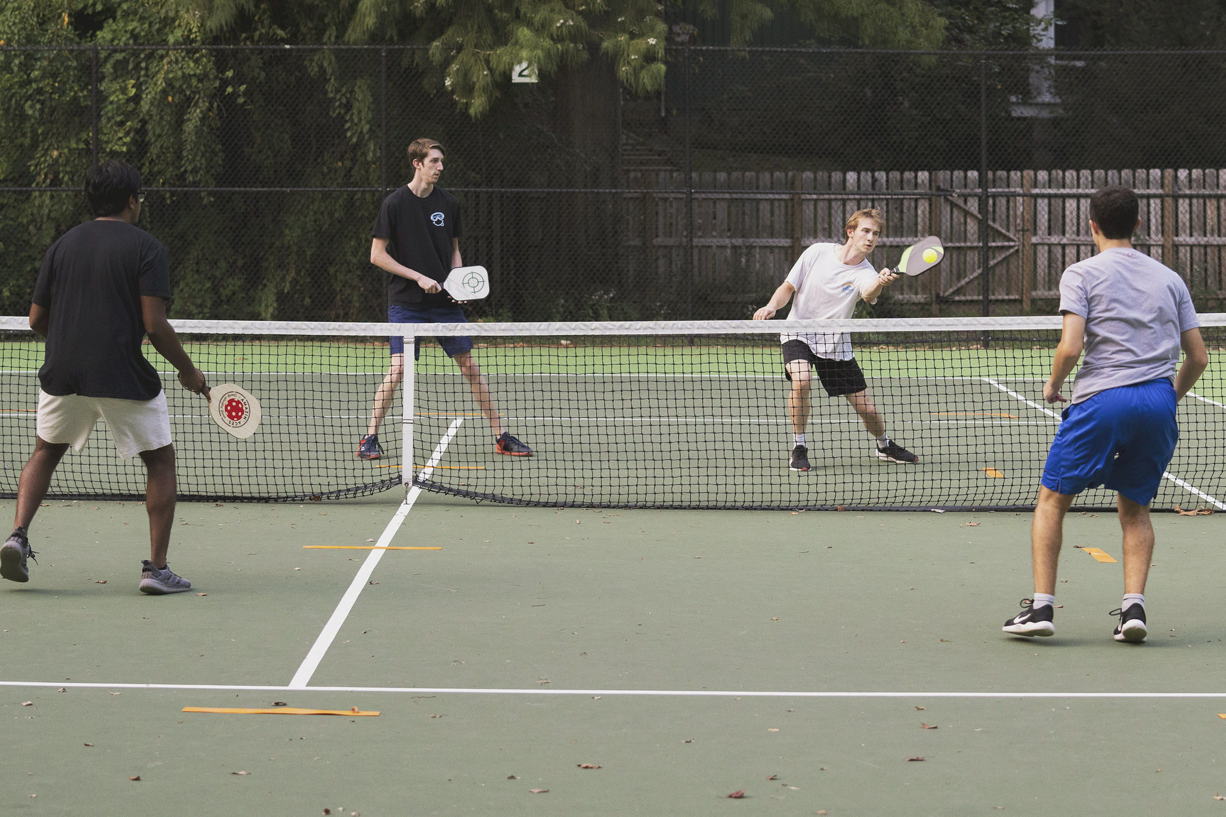 Four students playing Pickleball