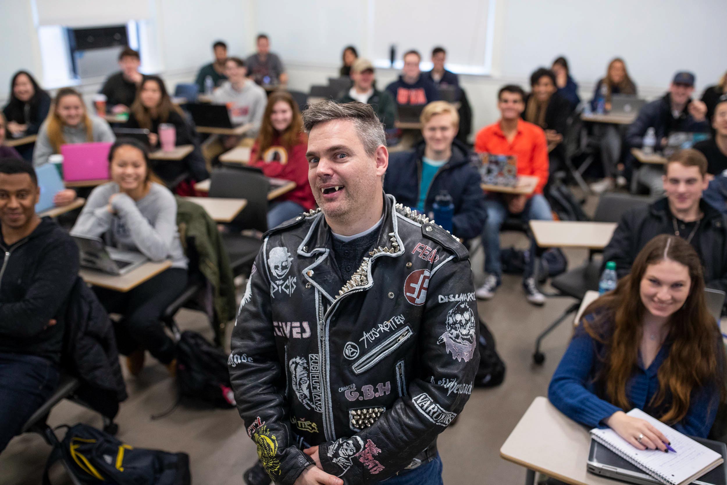 Professor Stanley Stepanic wearing vampire teeth and leather in class