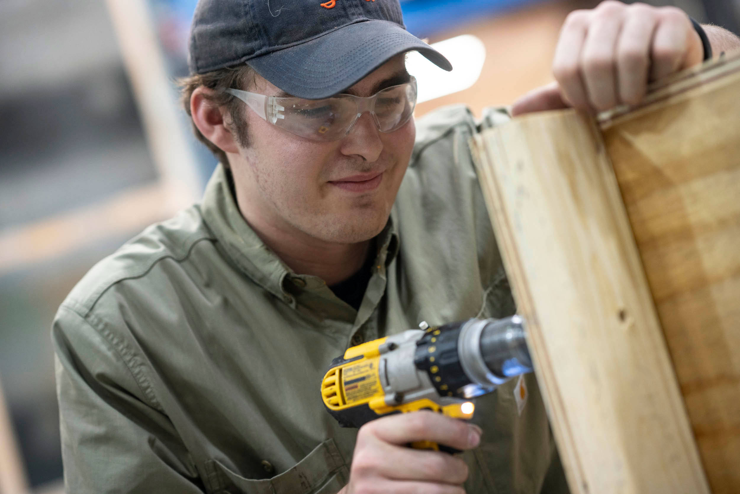 Jackson Key drilling a hole in the wood