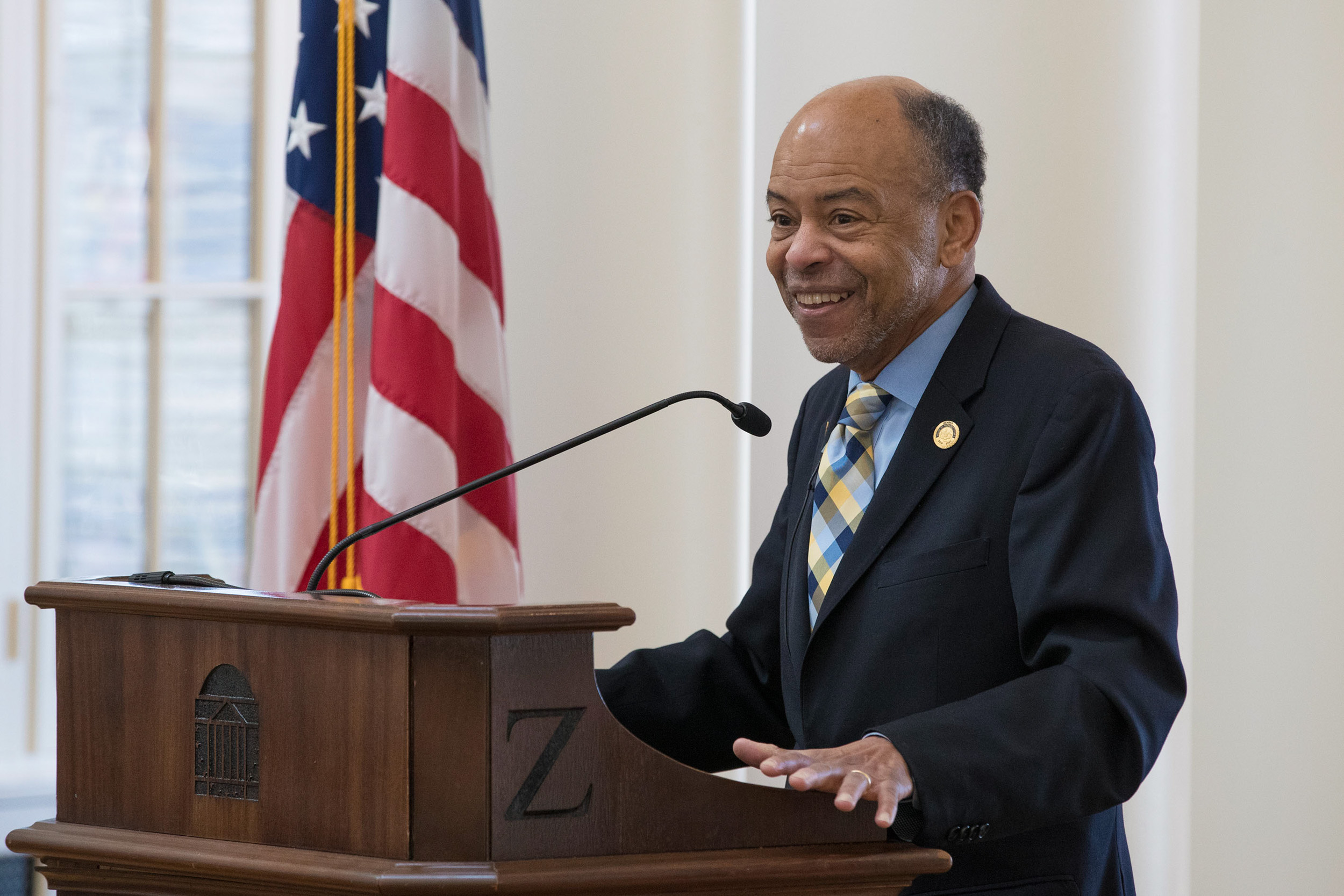 Roebuck speaking at a podium