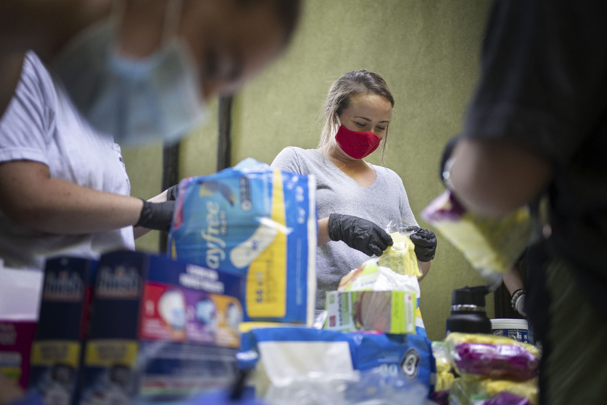 Taylor, center helping to pack famine hygiene bags