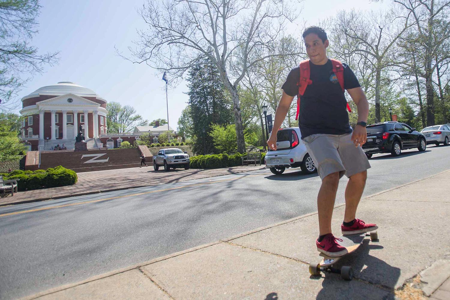 Jesus Gomez riding a skateboard on the sidewalk