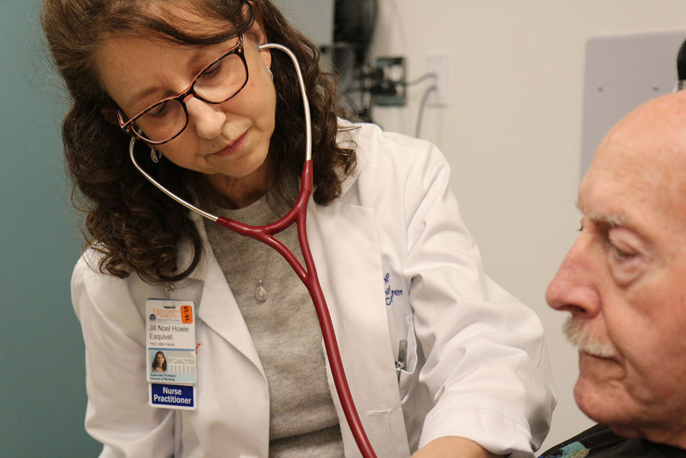 Nurse Practitioner listening to a patients heart