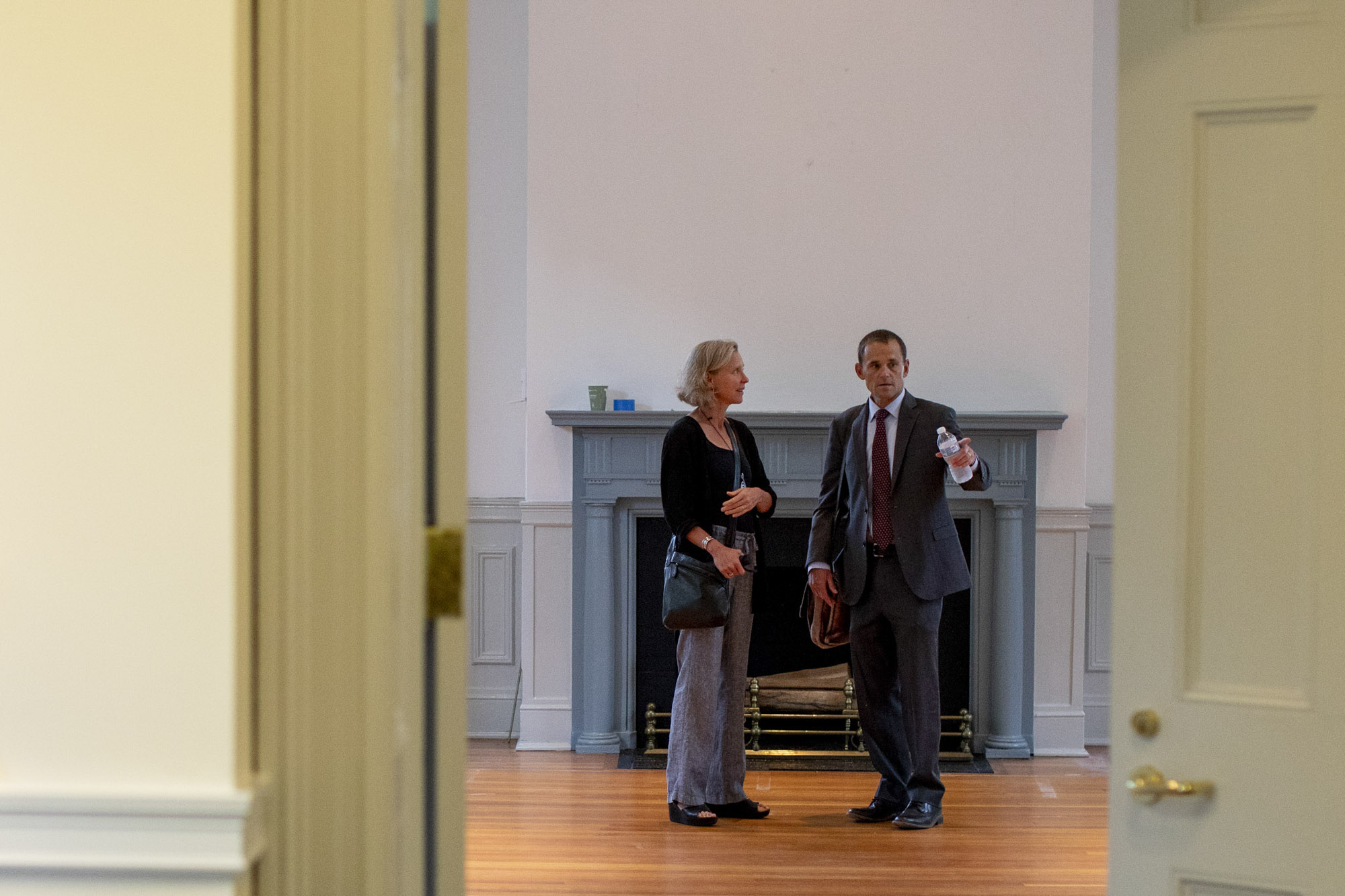 President Jim Ryan and his wife stand in an empty room in a building on the Lawn