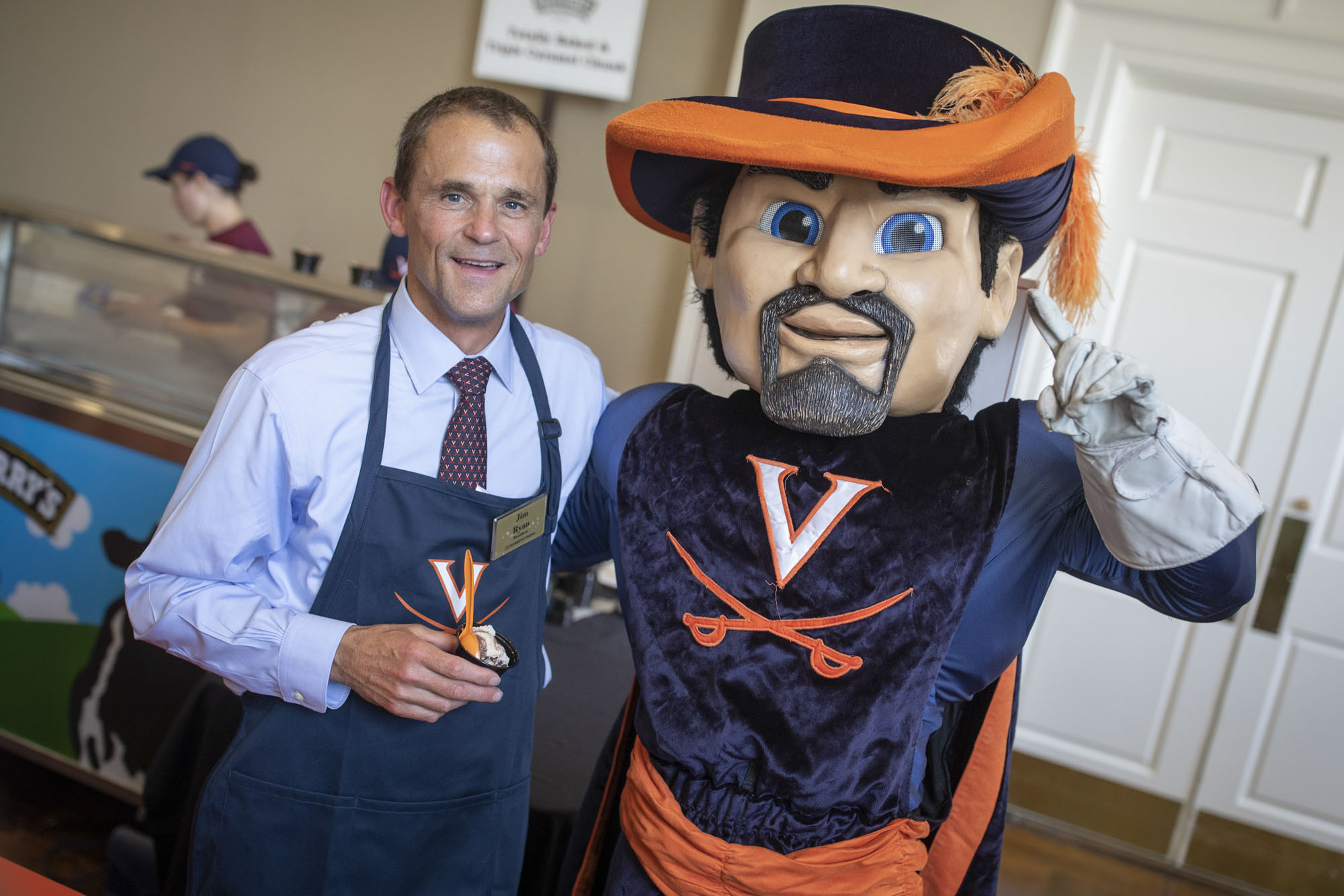 Jim Ryan stands with the Cav Man holding icecream 