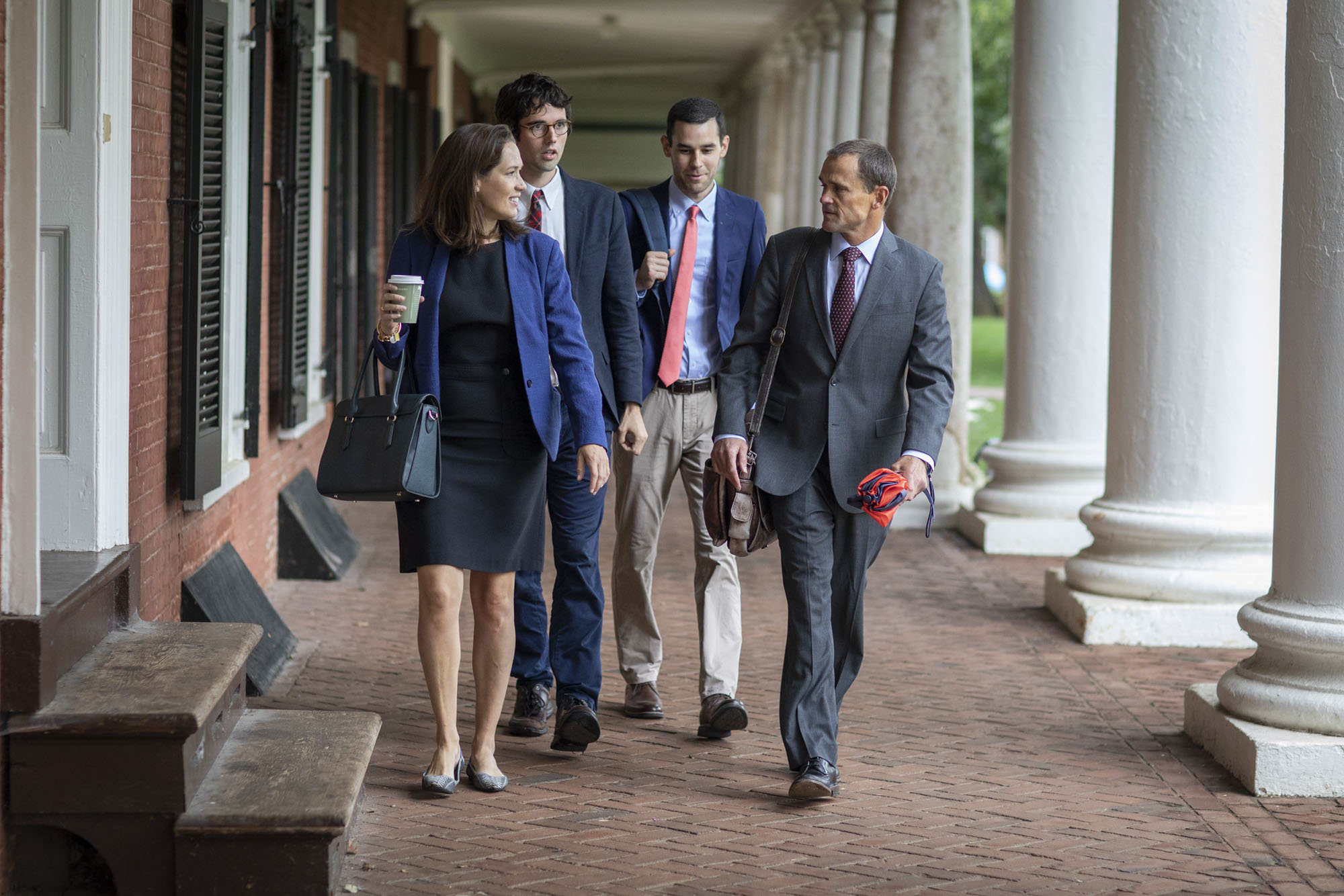 President Jim Ryann walking down the sidewalk with three other people