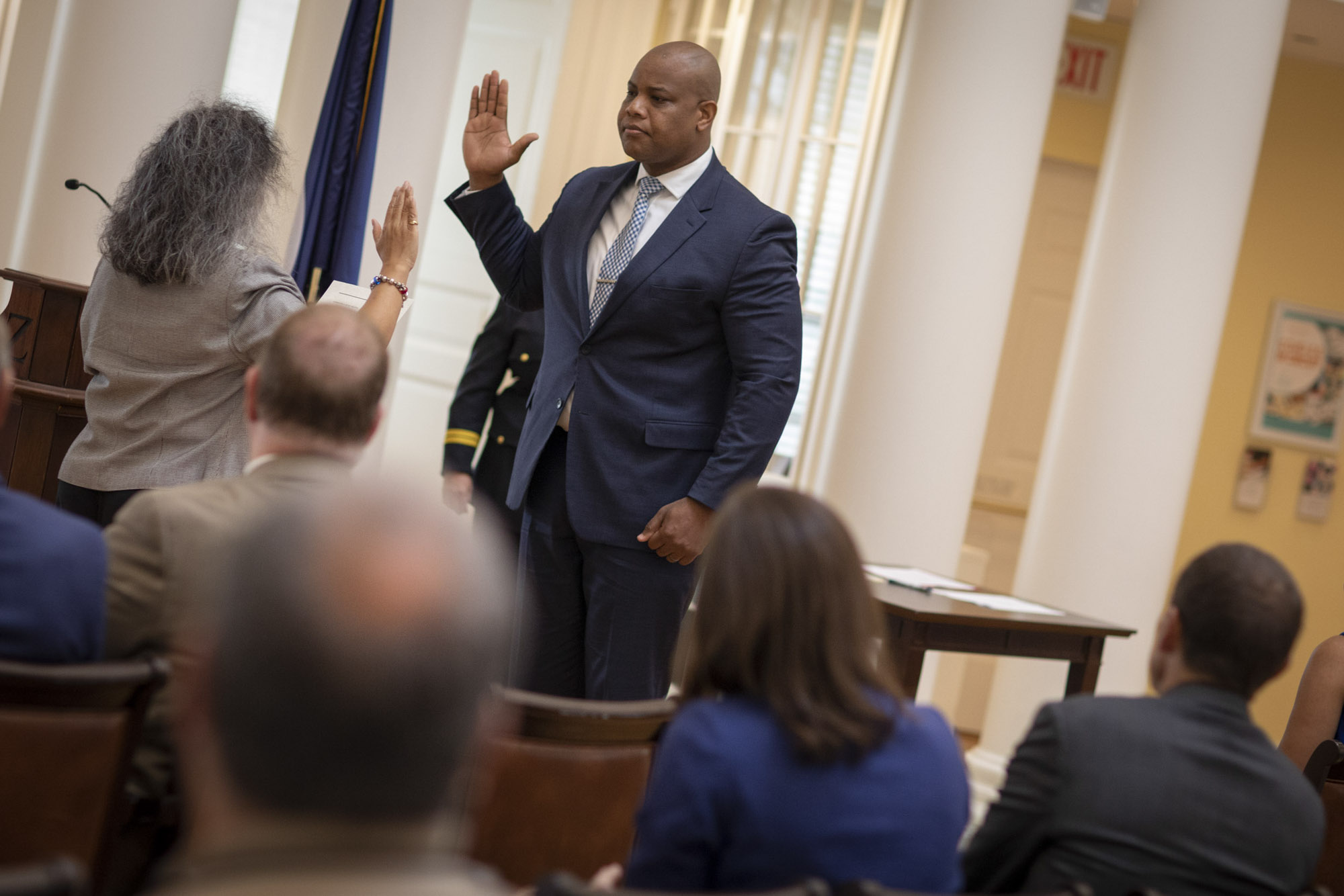 Man getting sworn in by a woman