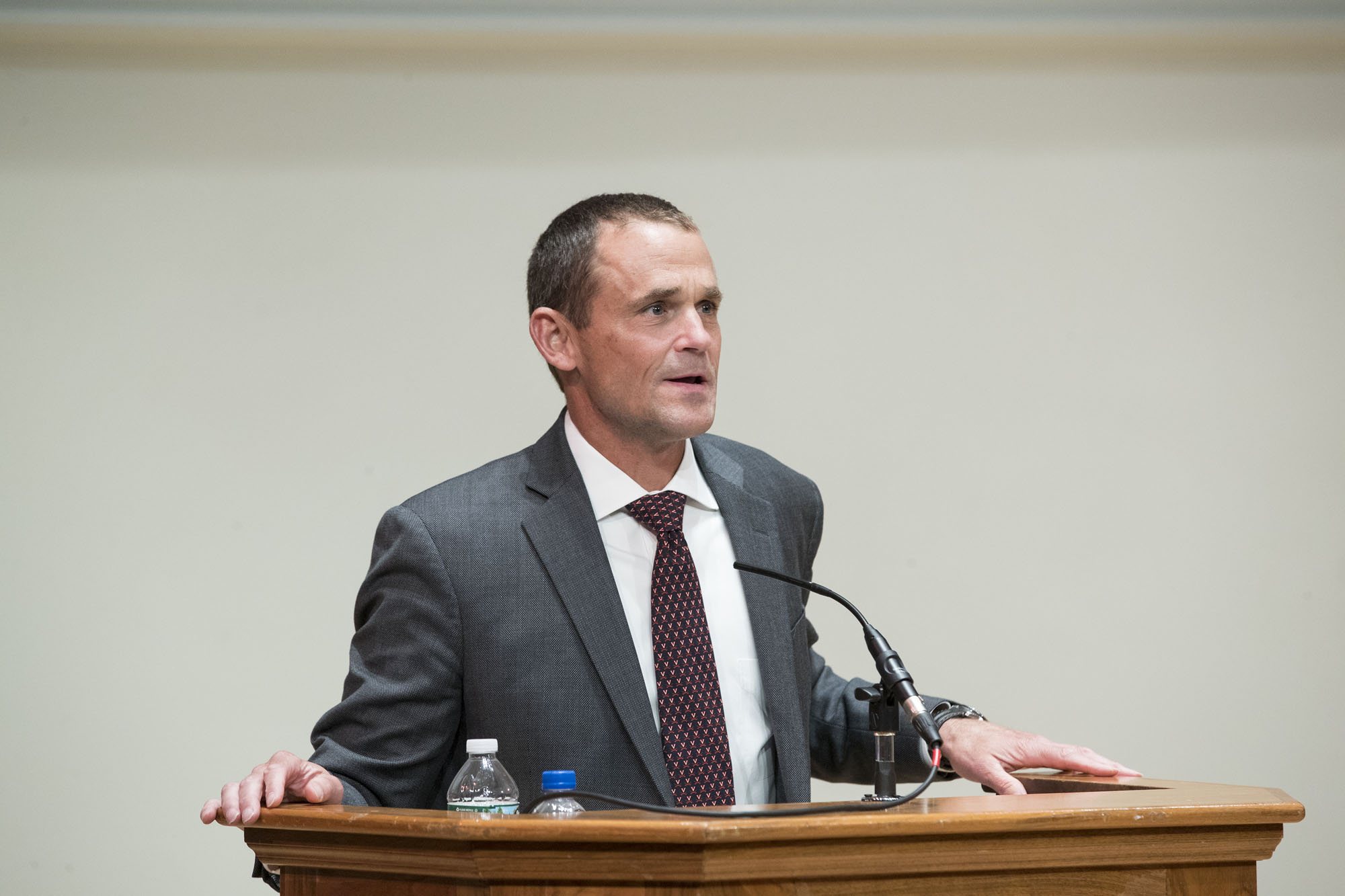 President James E. Ryan stands at a podium giving a speech to the first year parents