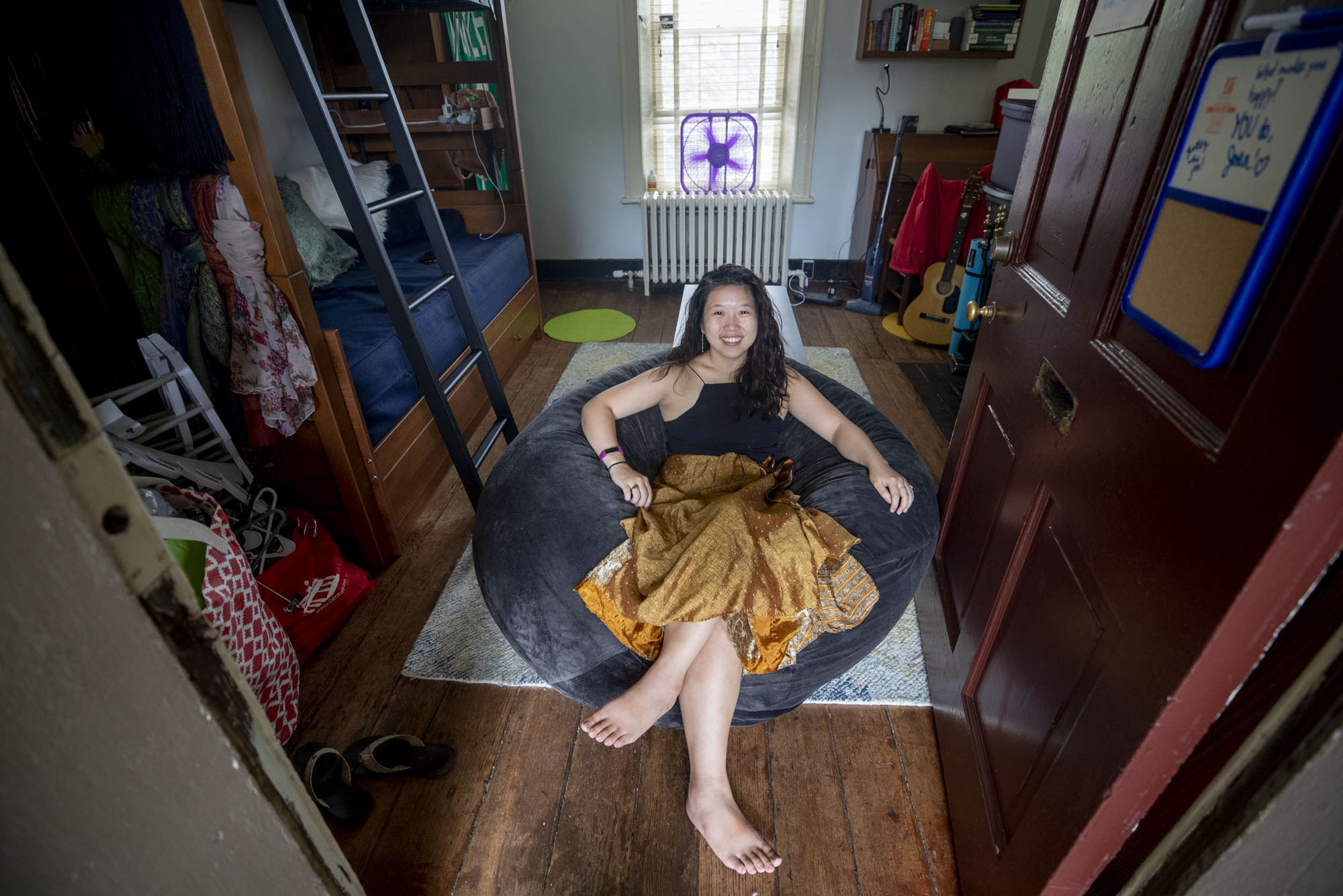 Joan lee sits in a bean bag chair in the middle of her lawn Room