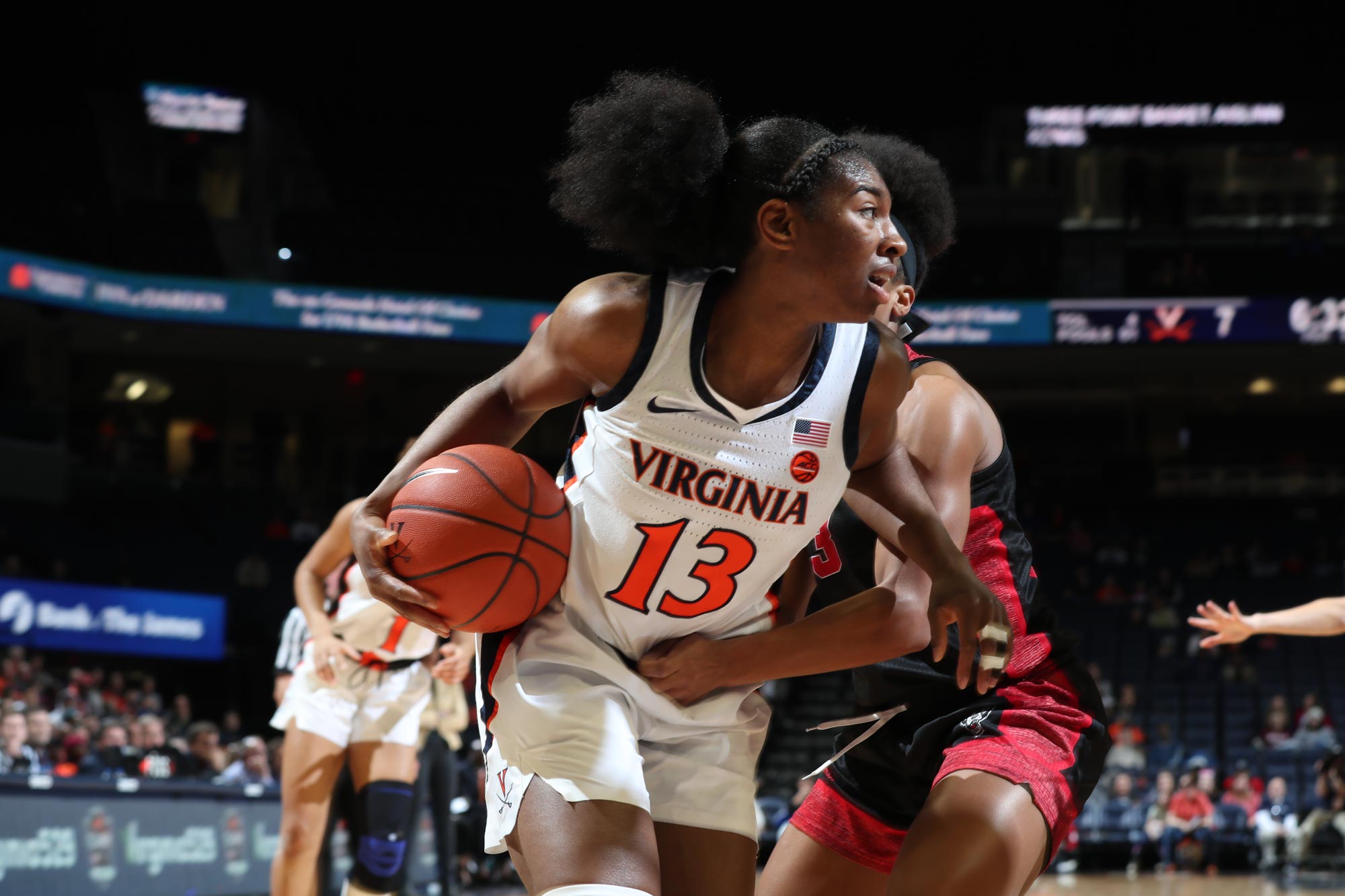 Willoughby dribbling the basketball as an opponent tries to stop her