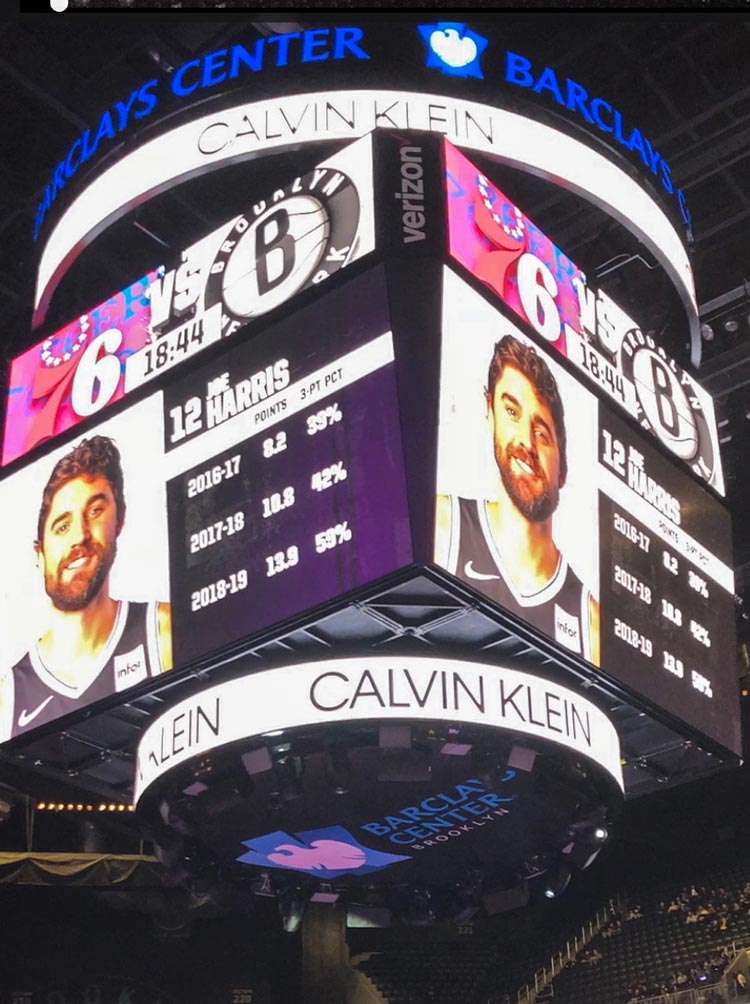 Harris basketball image on the jumbotron with his stats