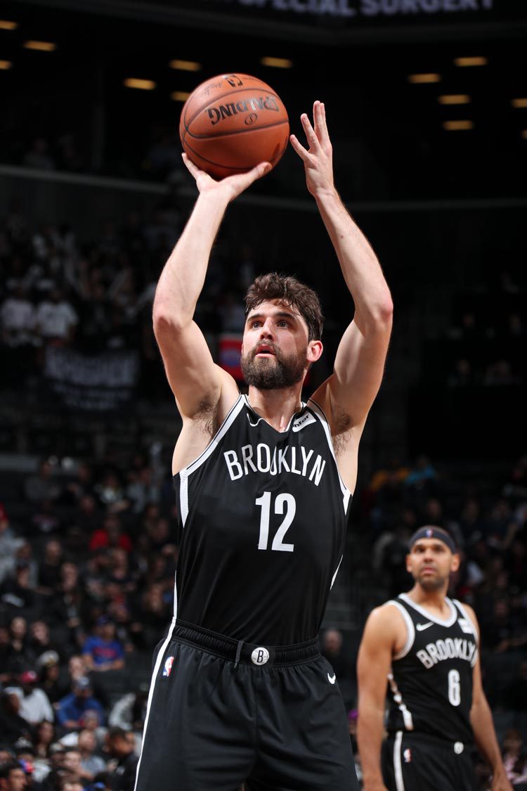 Harris in a Brooklyn basketball uniform shooting the basketball