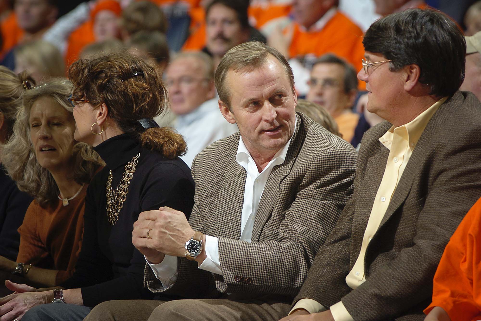 John Grisham sitting in the crowd at a basketball game