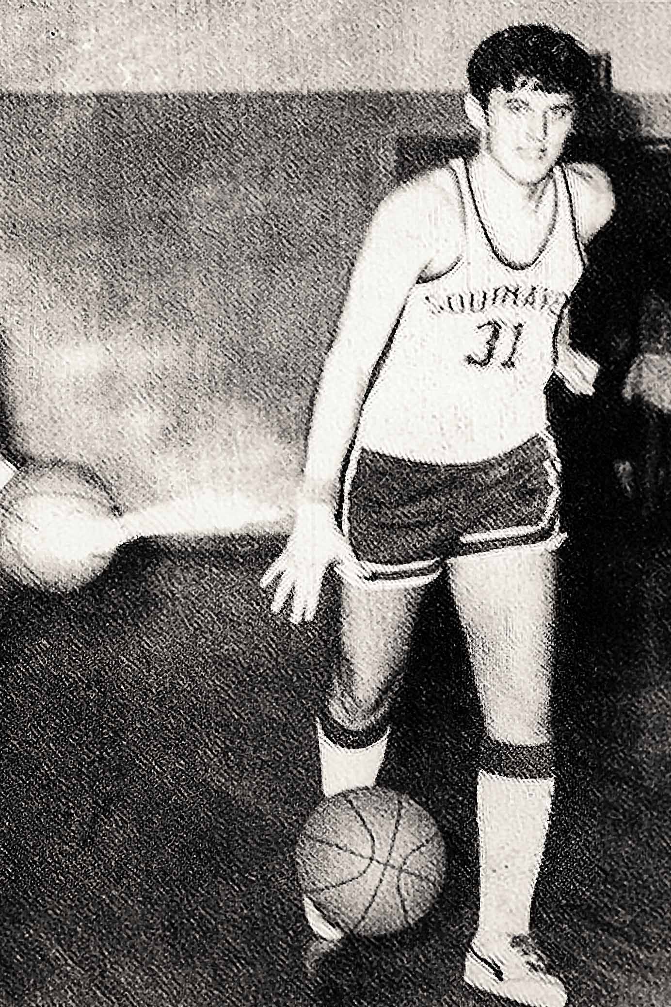 Yearbook photo of Grisham  playing basketball