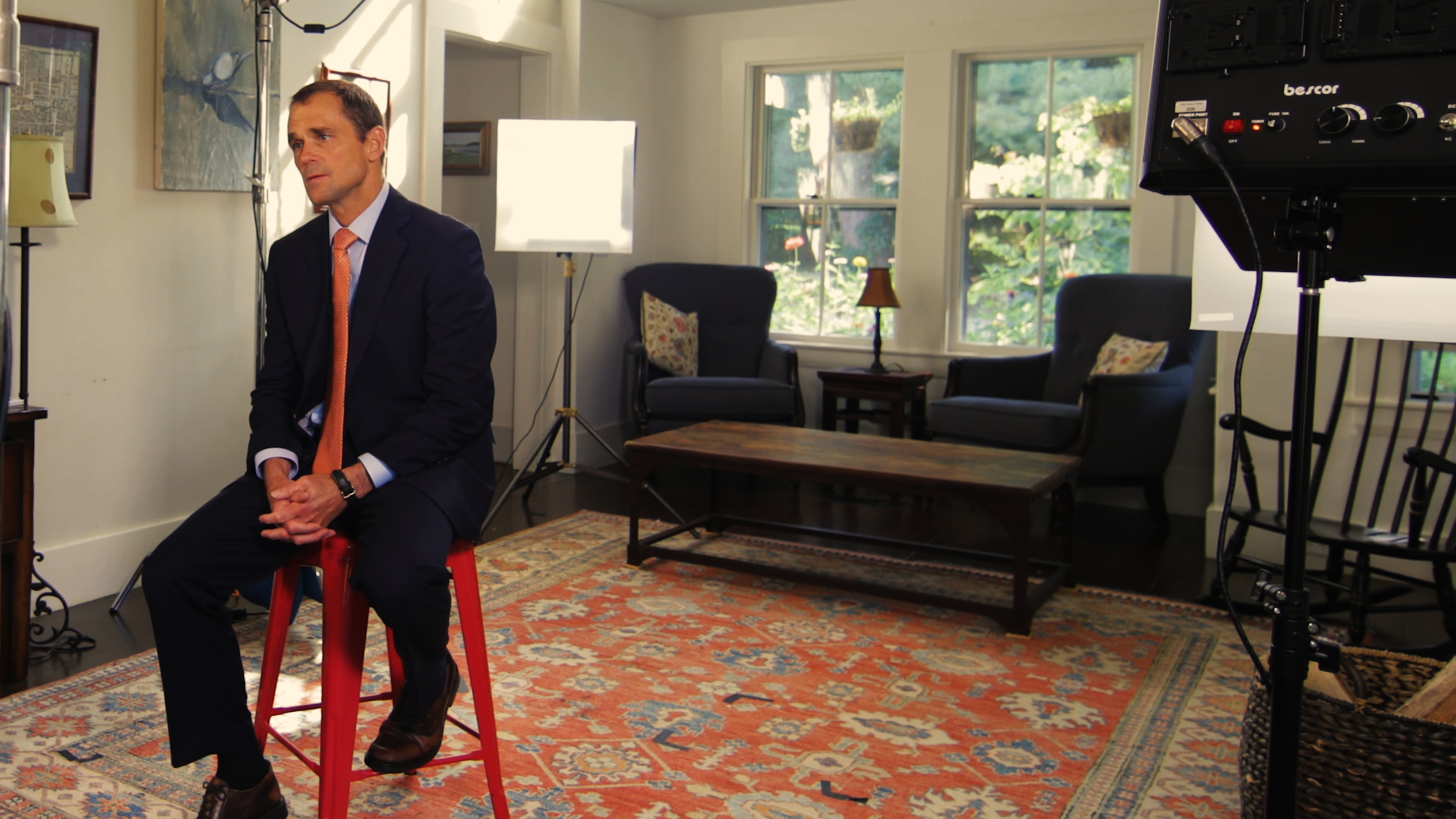 President Jim Ryan sitting on a barstool preparing to film a video