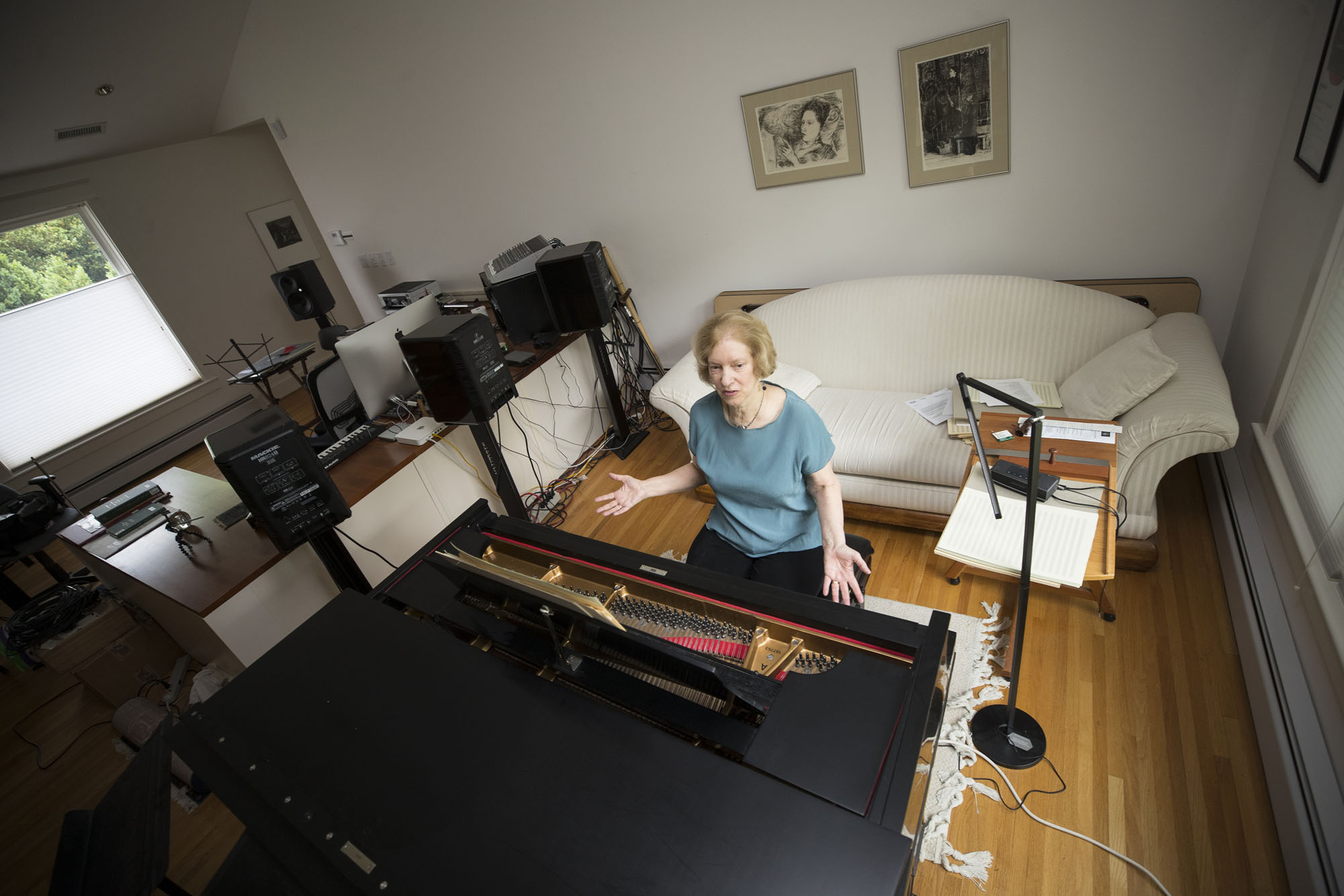 Judith Shatin sits at a piano