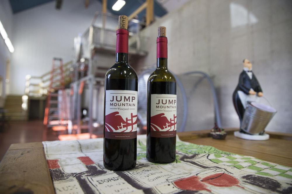 Two Jump Mountain Vineyard bottles sit on a table