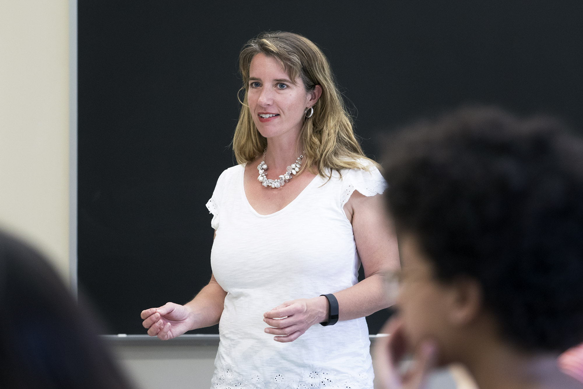 Kate Stephenson standing in front of a class speaking