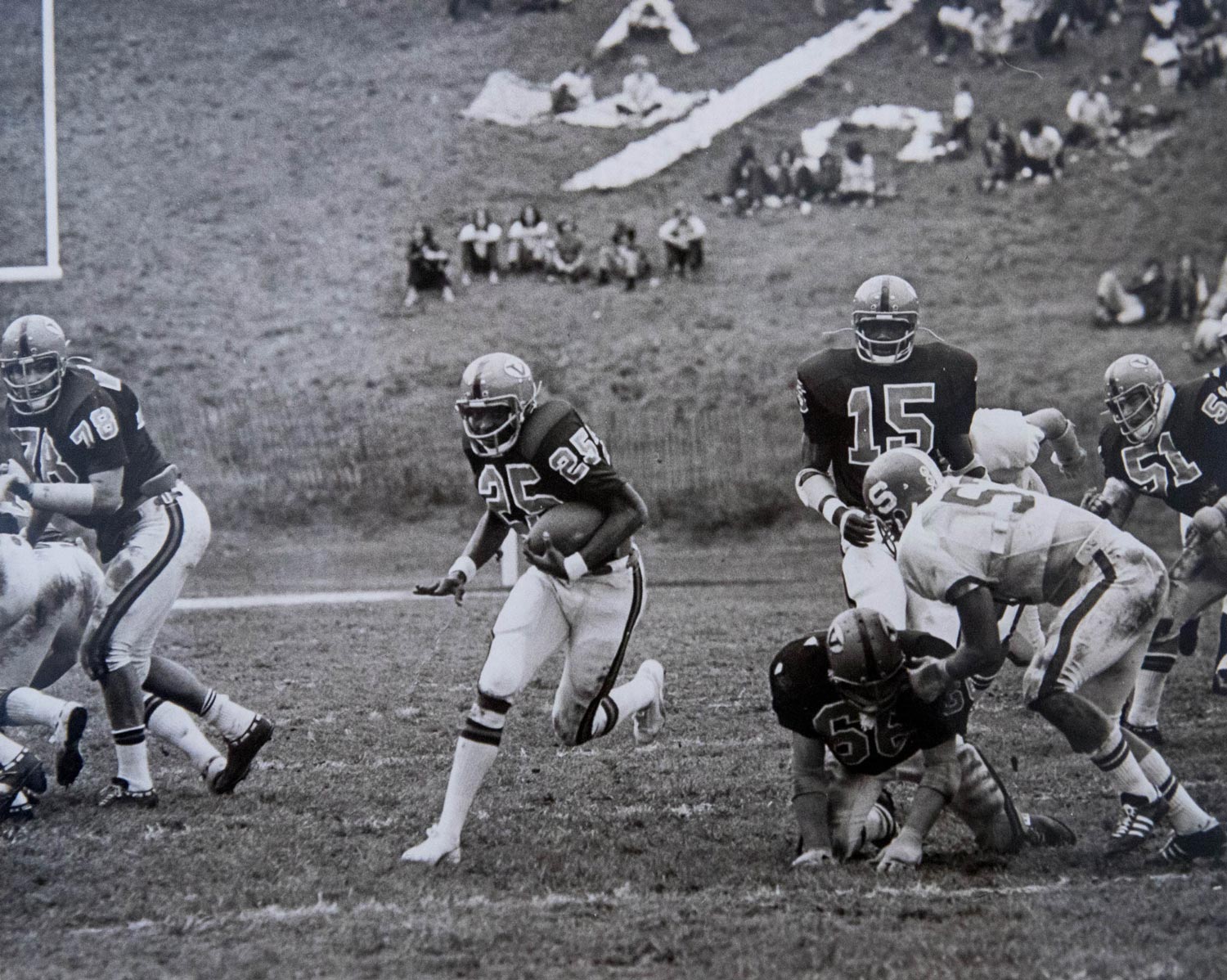 Kent Merritt running with the football during a game, black and white image