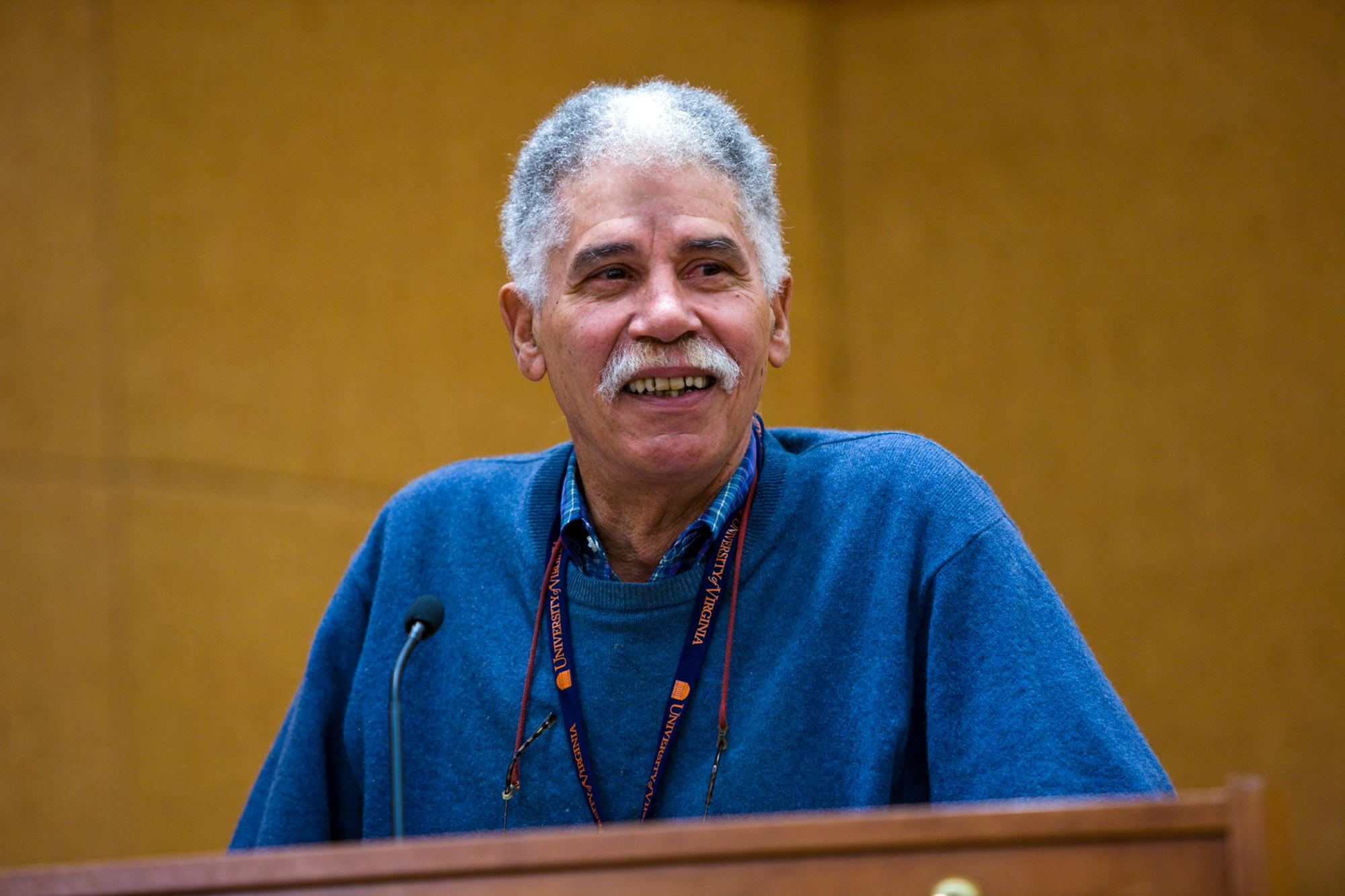 John F. Merchant stands at a podium giving a speech 