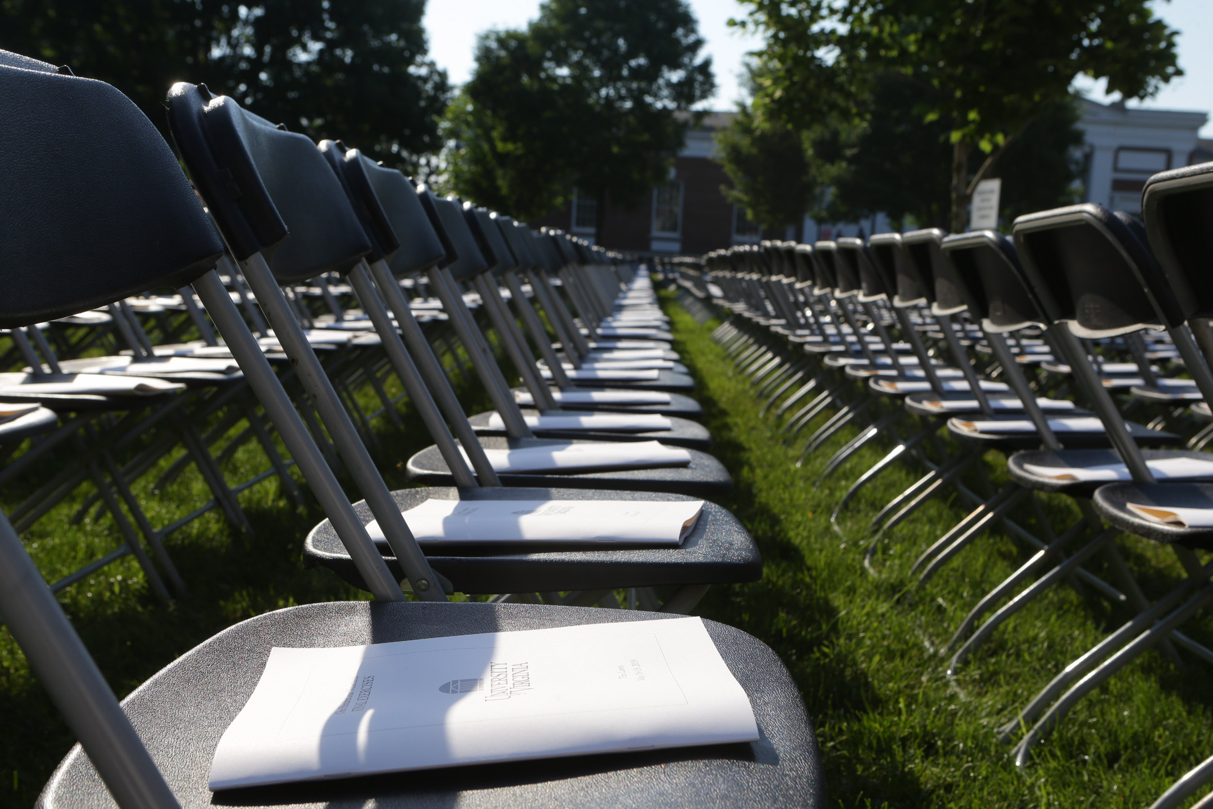 Empty chairs with graduation books on them