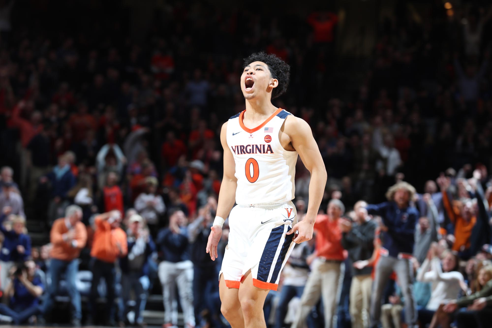 Kihei Clark stands on the court with mouth open screaming with joy