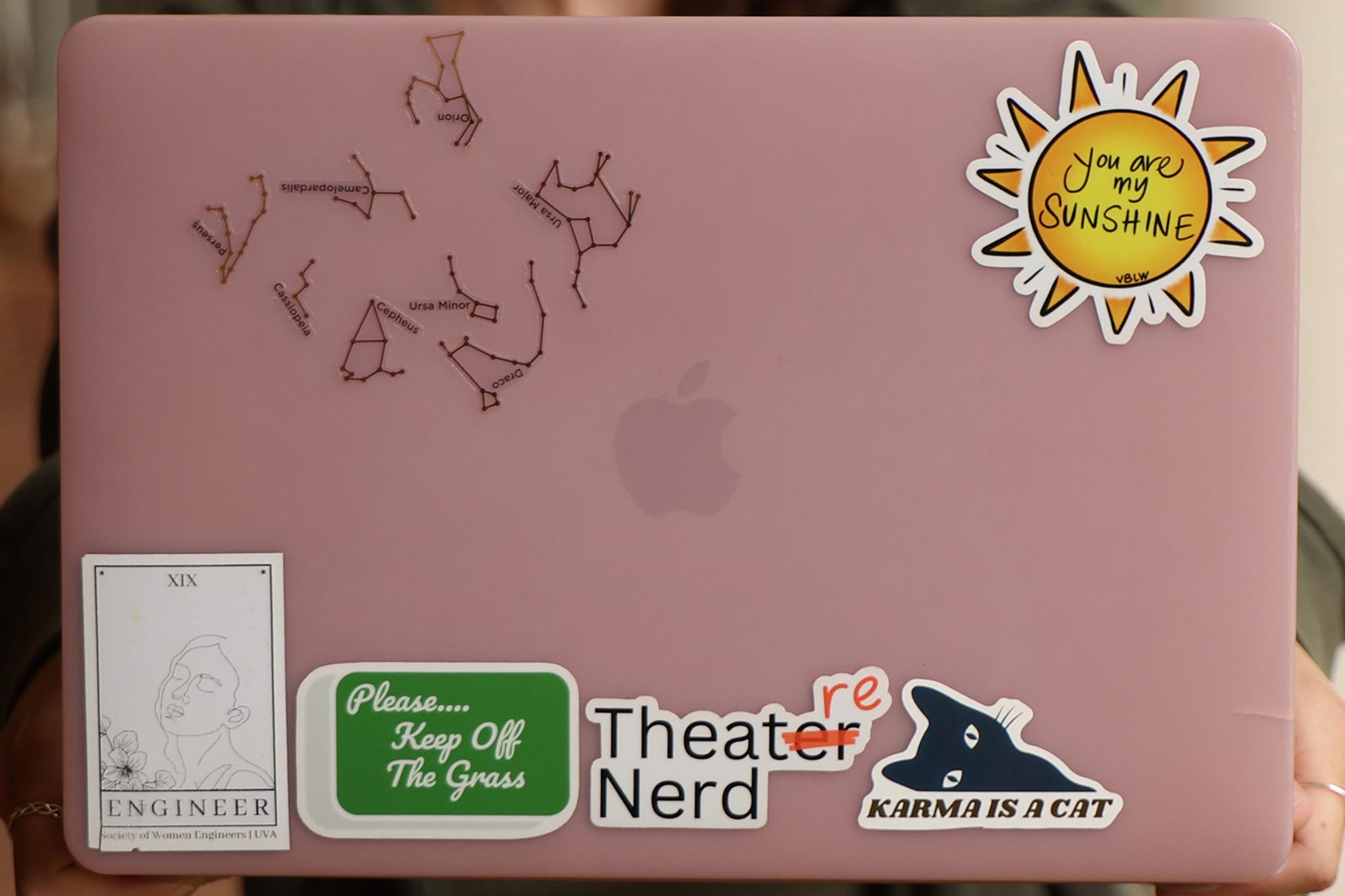 Taylor Thomas’s laptop adorned with stickers showing her love of astronomy, engineering, music, and affirmations.
