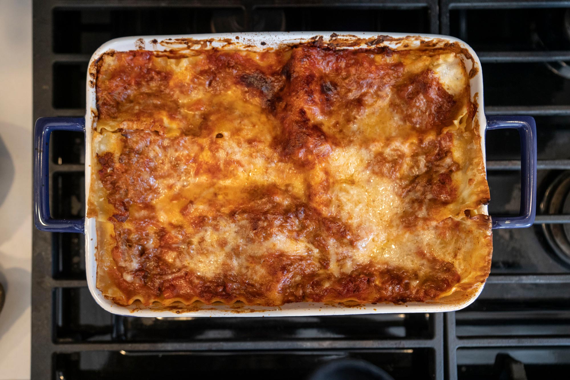 Cooked Lasagna sitting on top of a stove