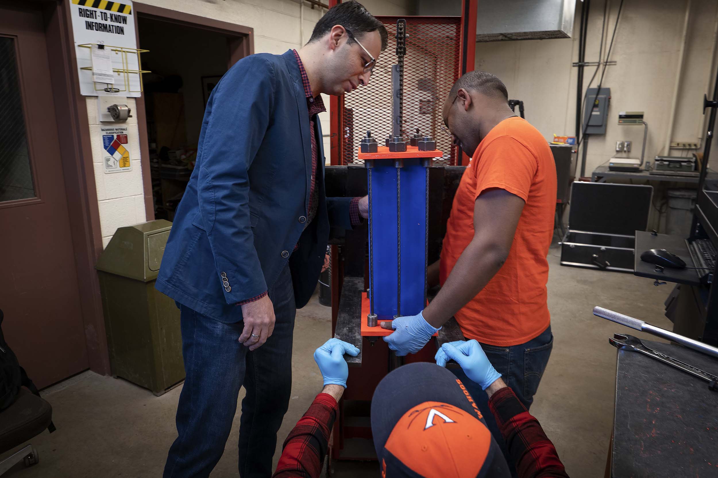 Ozbulut, left, works with Amedebrahan Asfaw, right, to prepare an earthquake damping machine