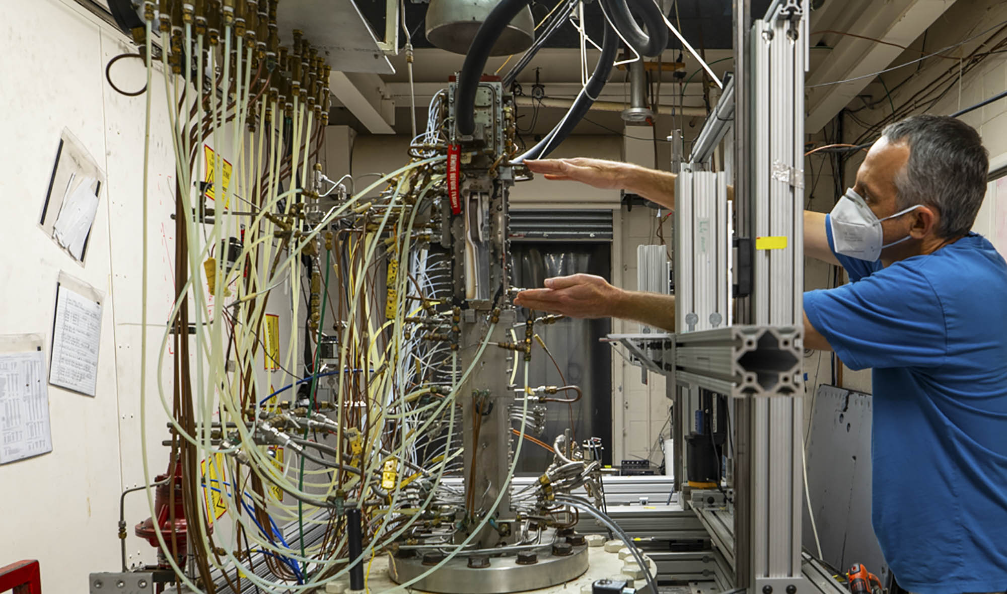 Christopher Goyne working on a machine in the lab