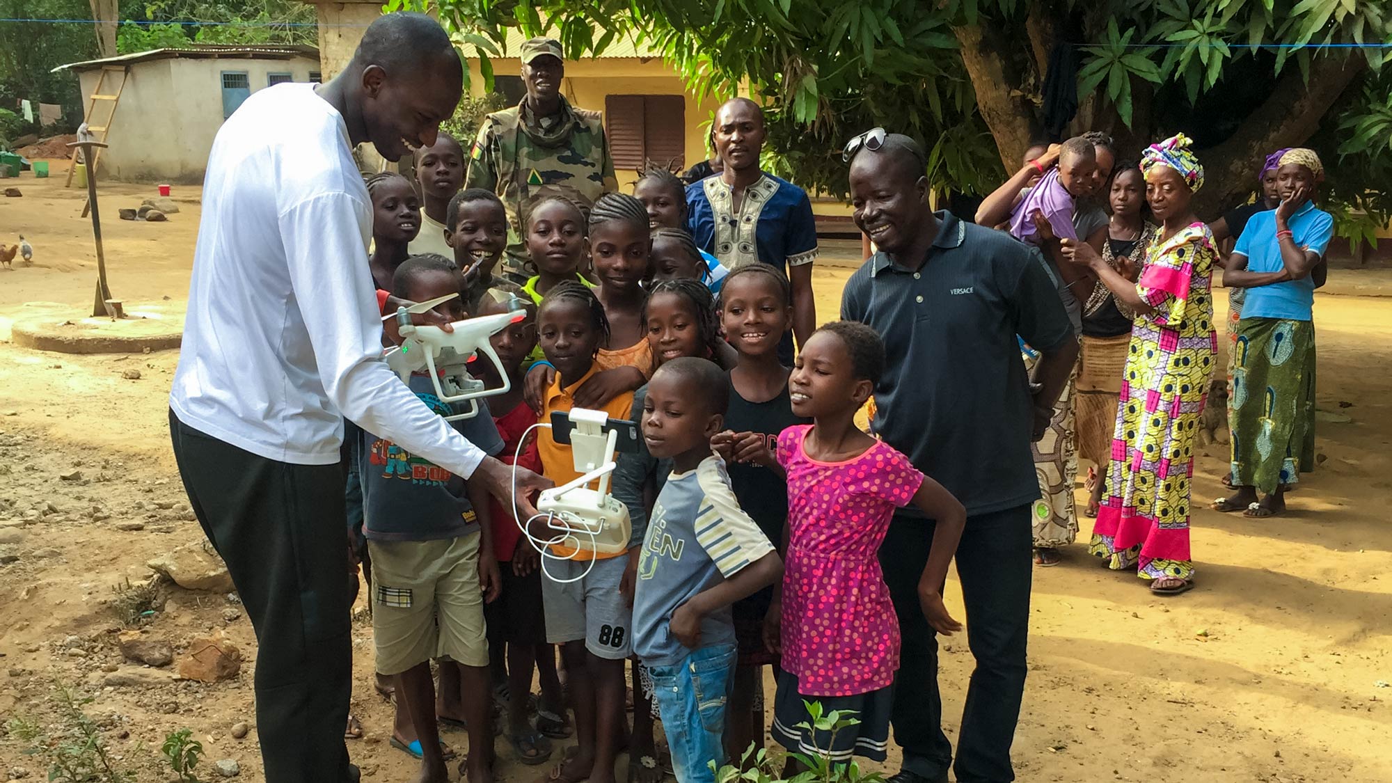 Diane playing with children in a Guinea village