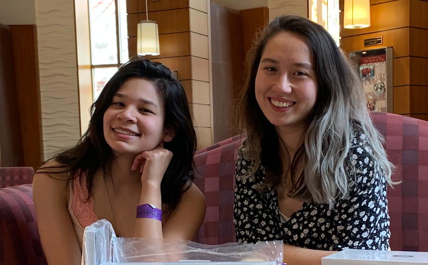 Danielle Zevitz, left, and Mara Hart, right sit at a table together smiling