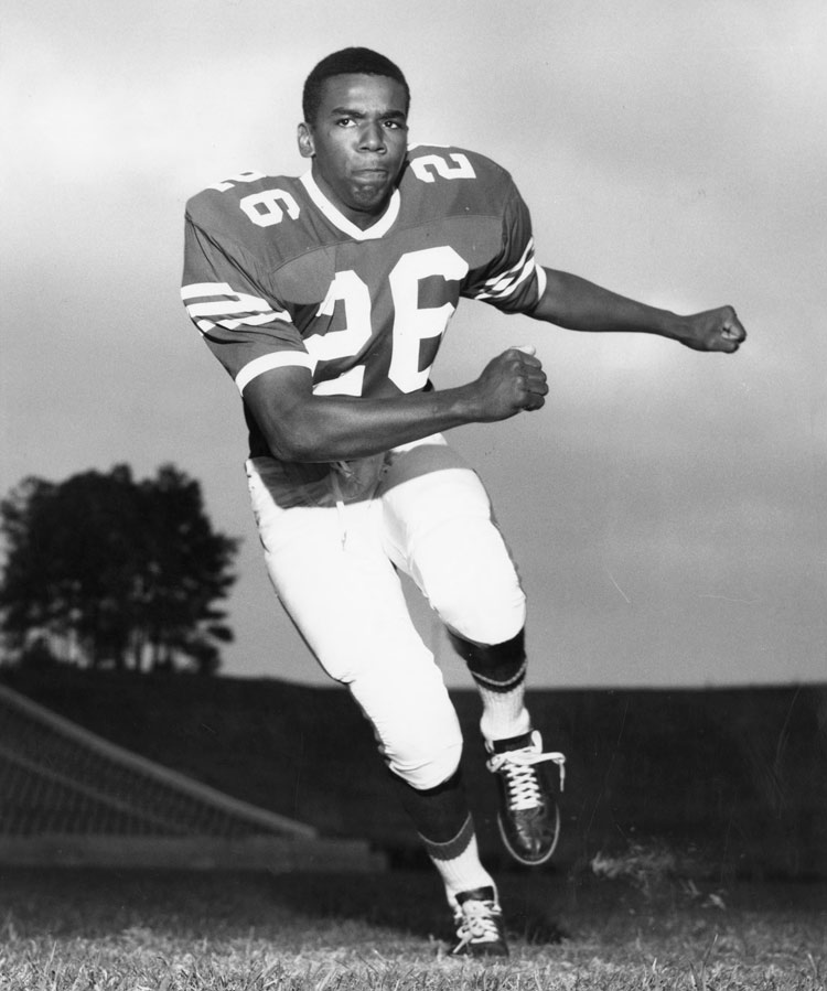 Marcus Martin running in football uniform, black and white image