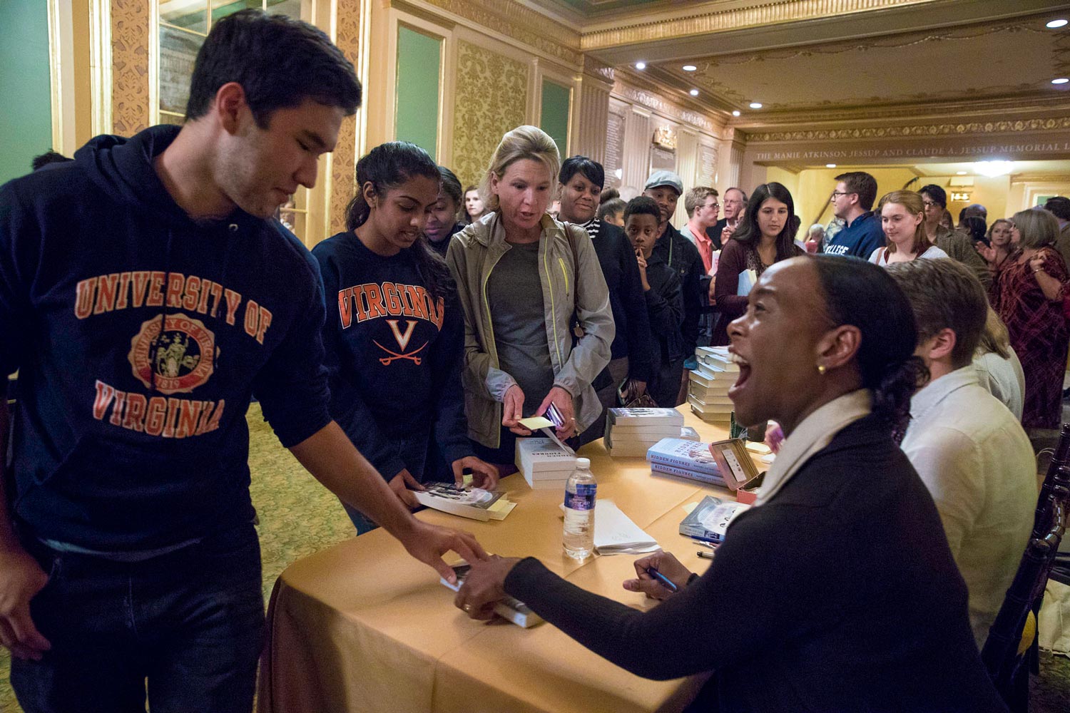 Author Margot Lee Shetterly signs a book for a student