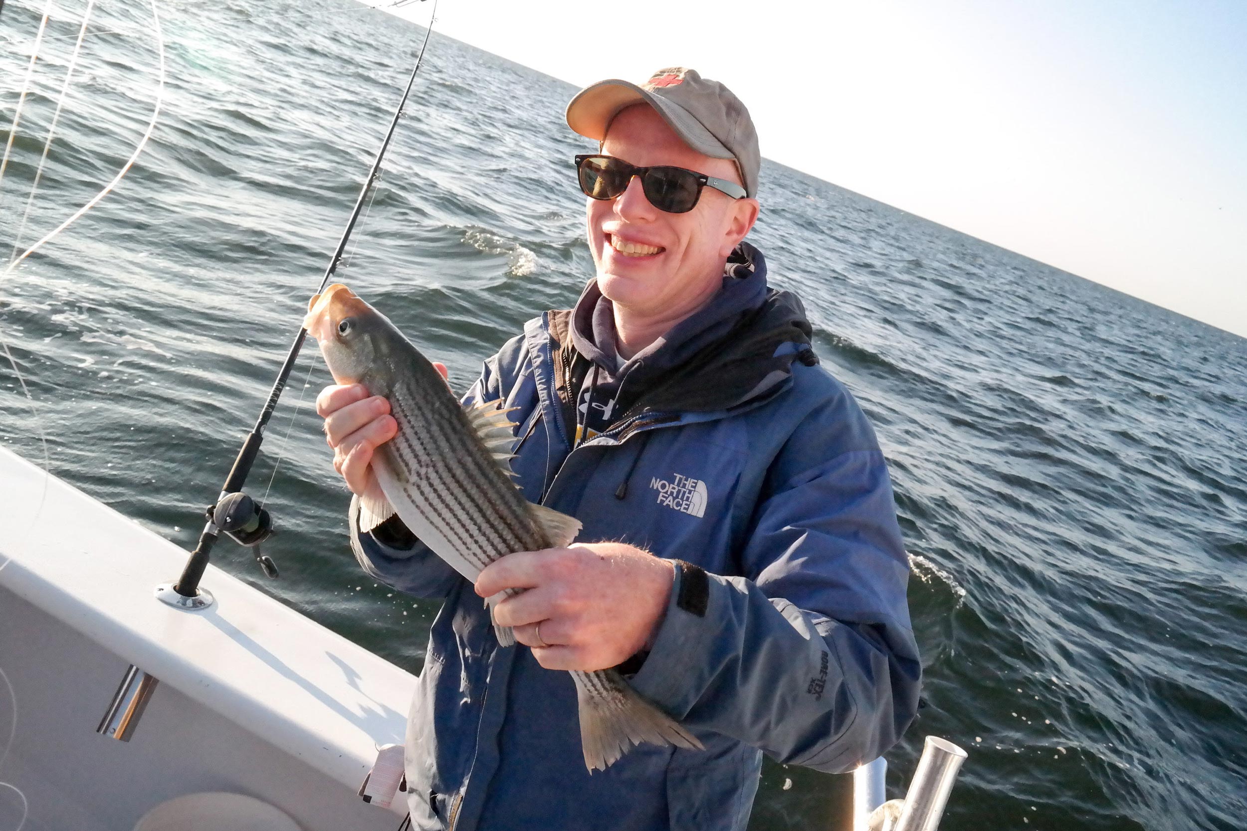 Peter Hedlund, director of Encyclopedia Virginia, took this photo of Mark Saunders in 2015 after he caught a striped bass, or rockfish, on their annual fishing trip in the Chesapeake Bay.