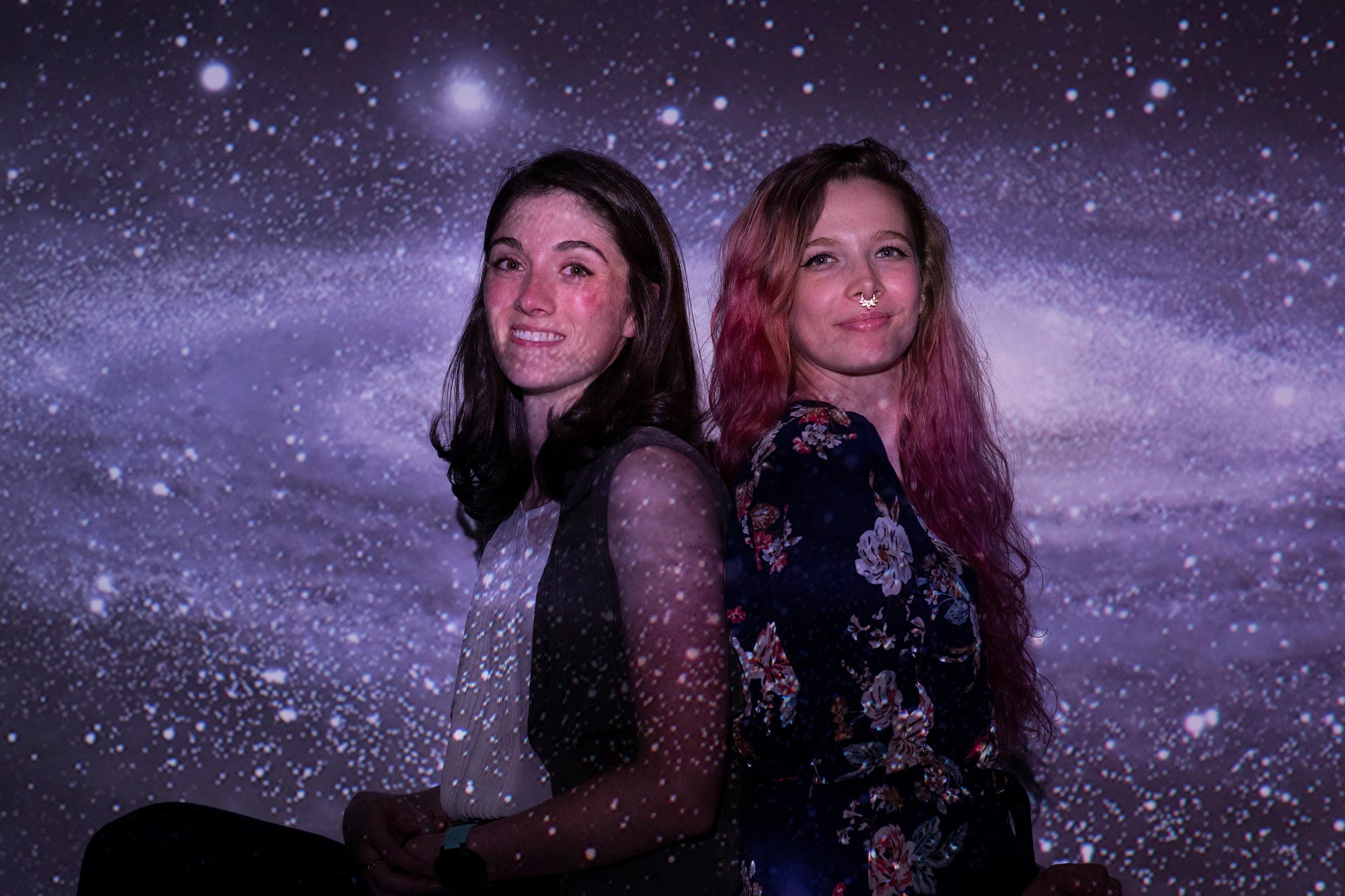 Mary Brewer (right) and Hannah Lewis, left stand back to bak while they are blended into the milkyway background