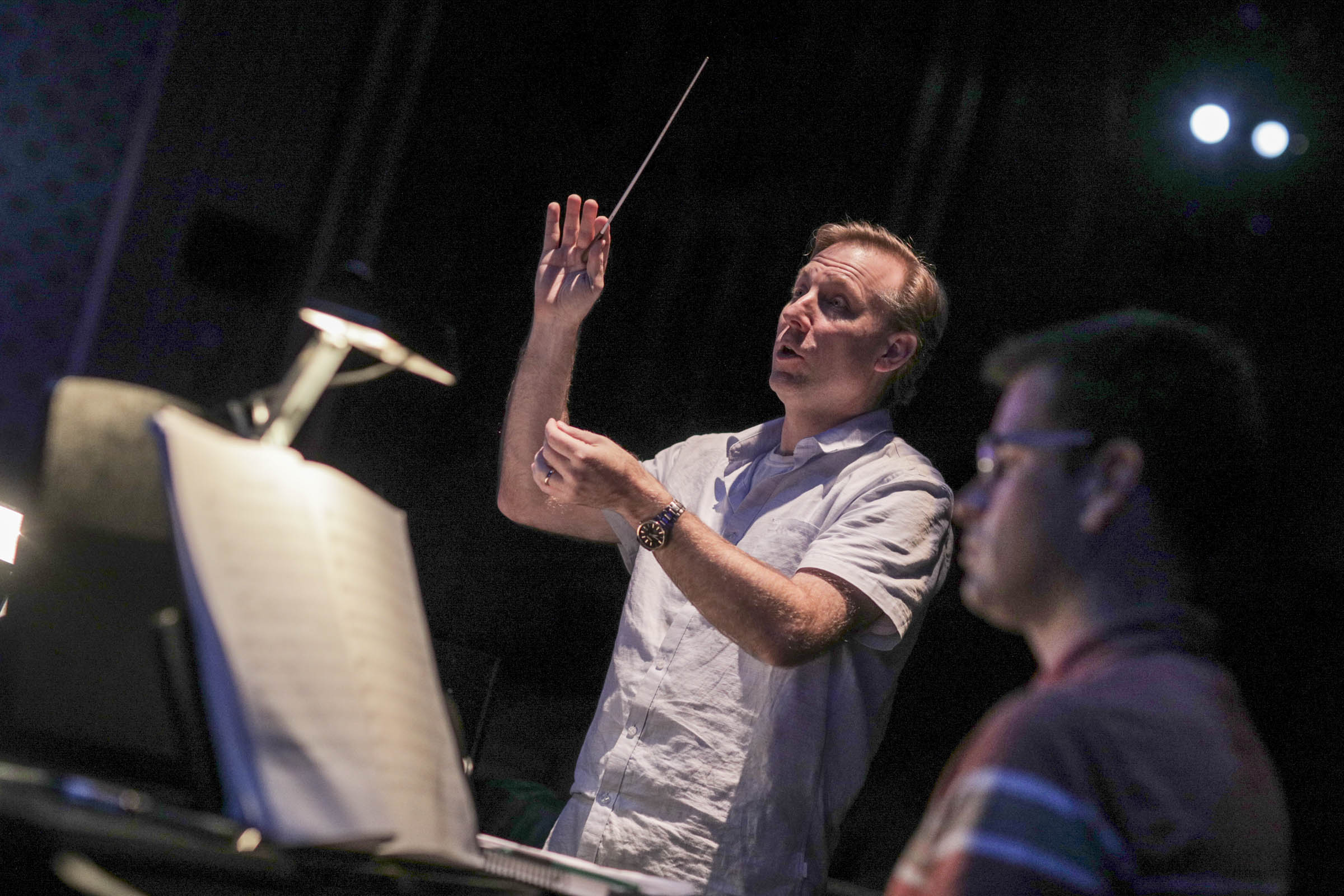 Director conducting the pit orchestra