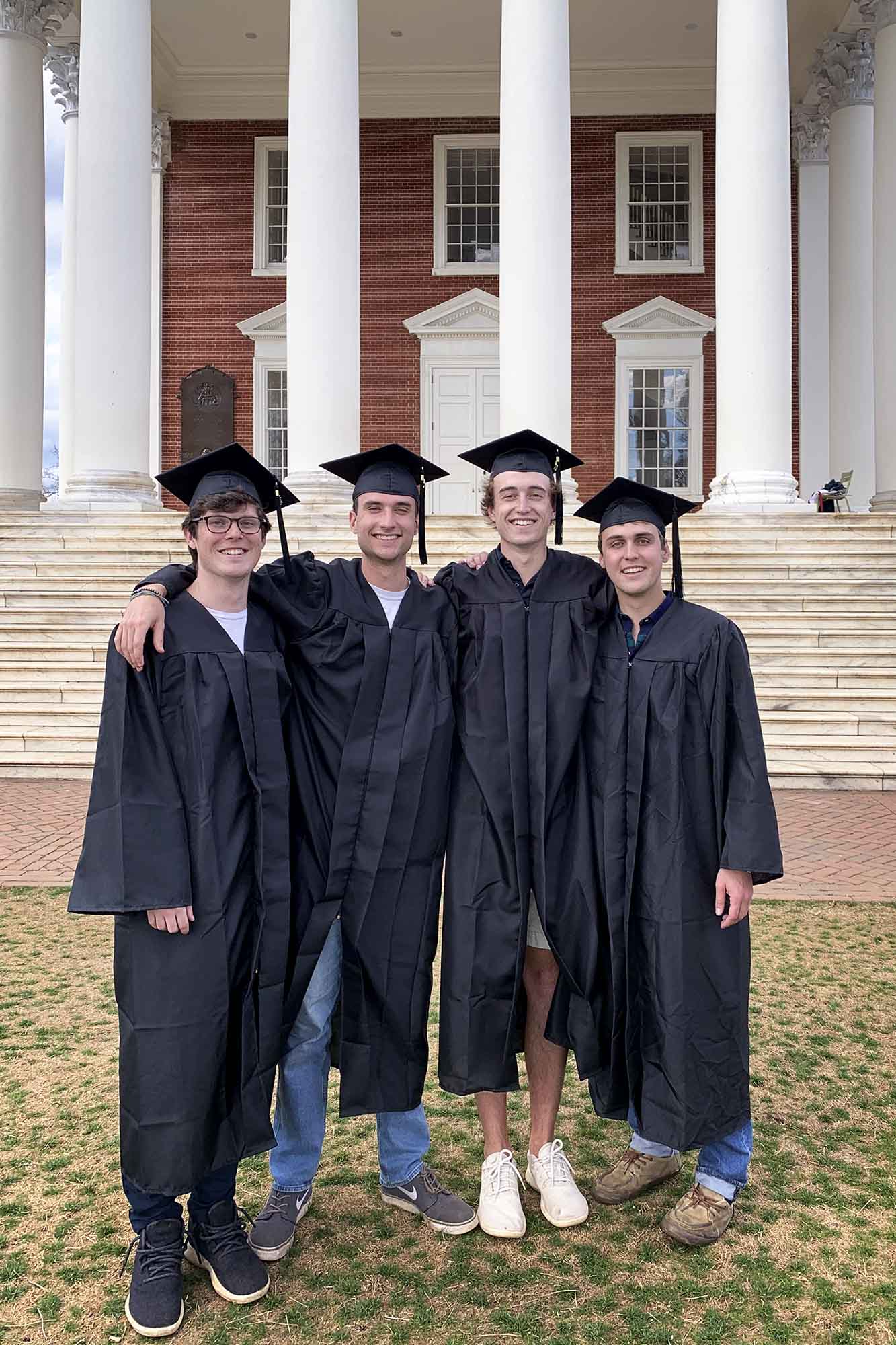 Sonnenblick and friends Cole Chisom, Sam LeFew and Elliott Gardner wear their graduation hat and gown to pose for a picture