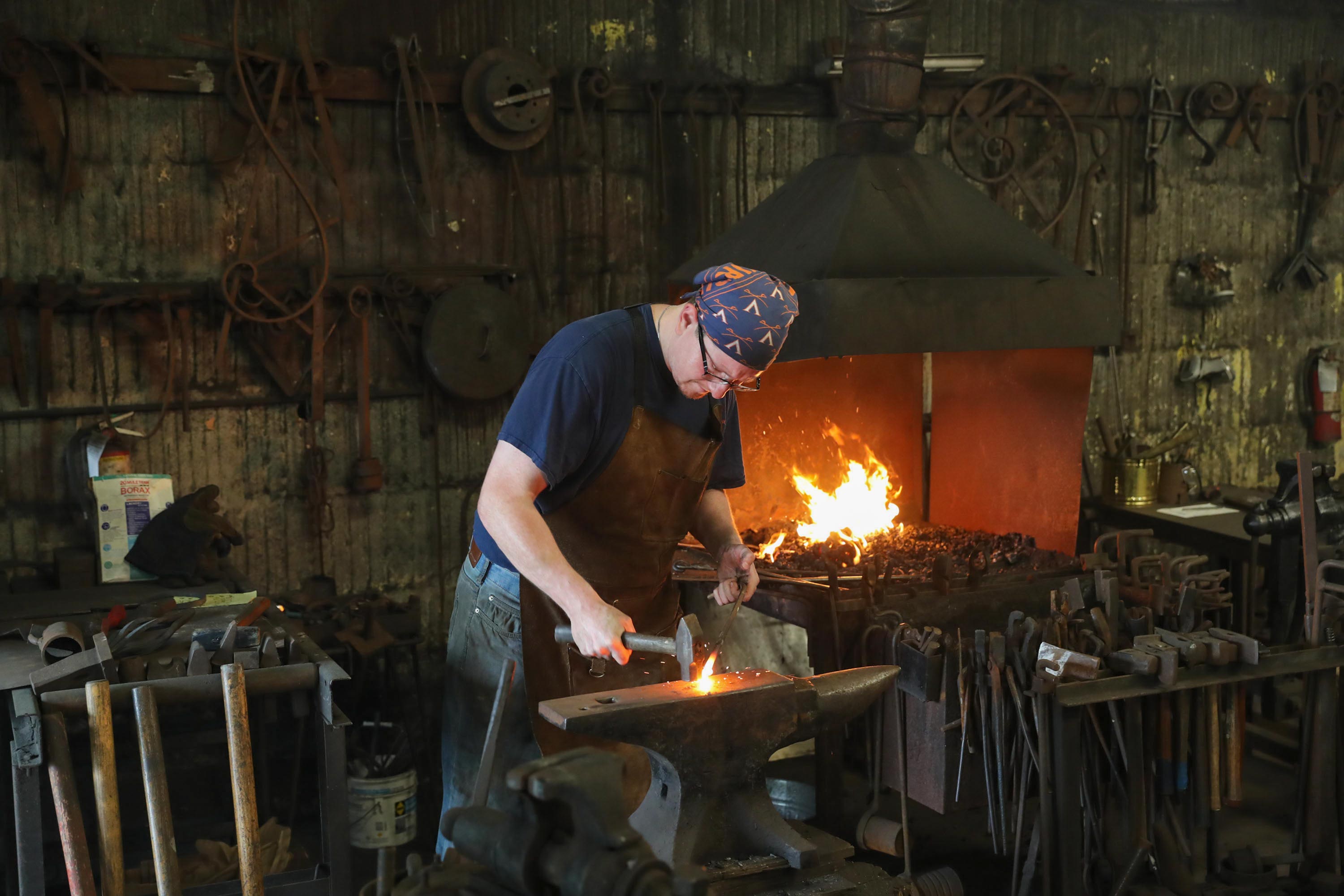 Matt Stromberg working in a blacksmithing area