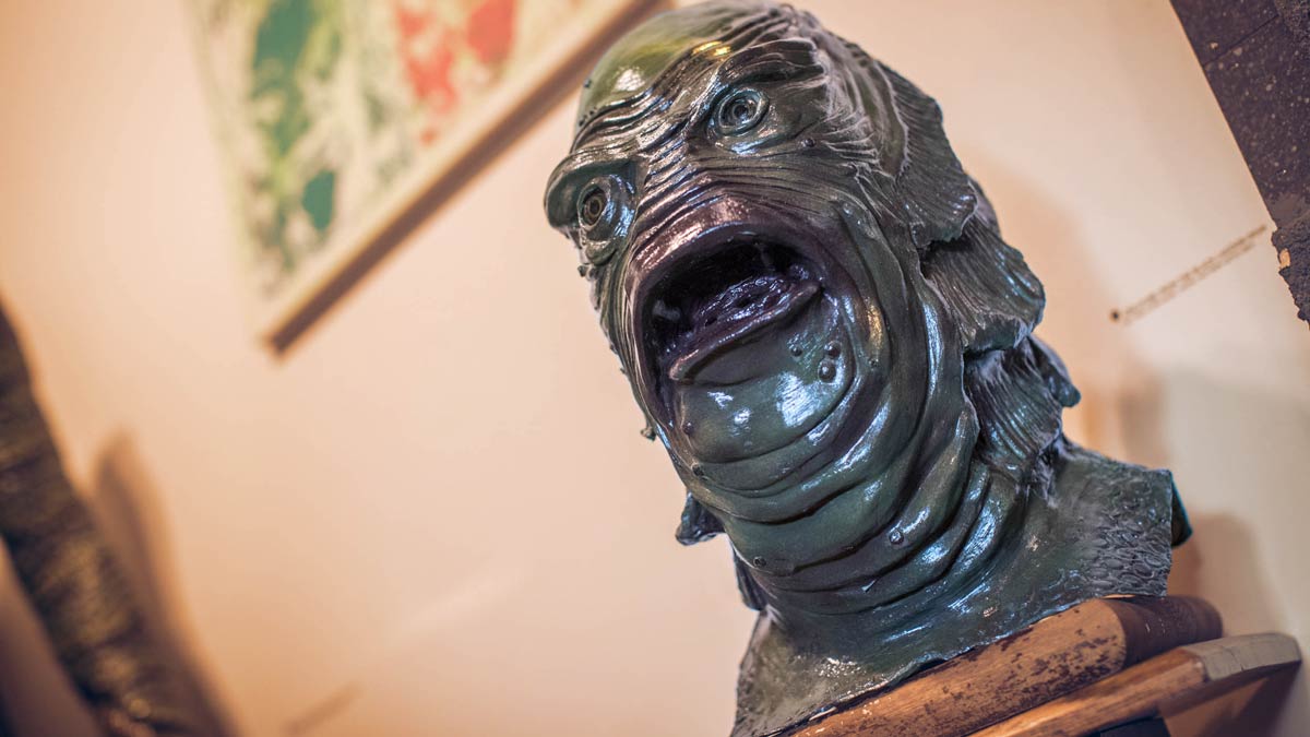 A gill-man mask on a pedestal